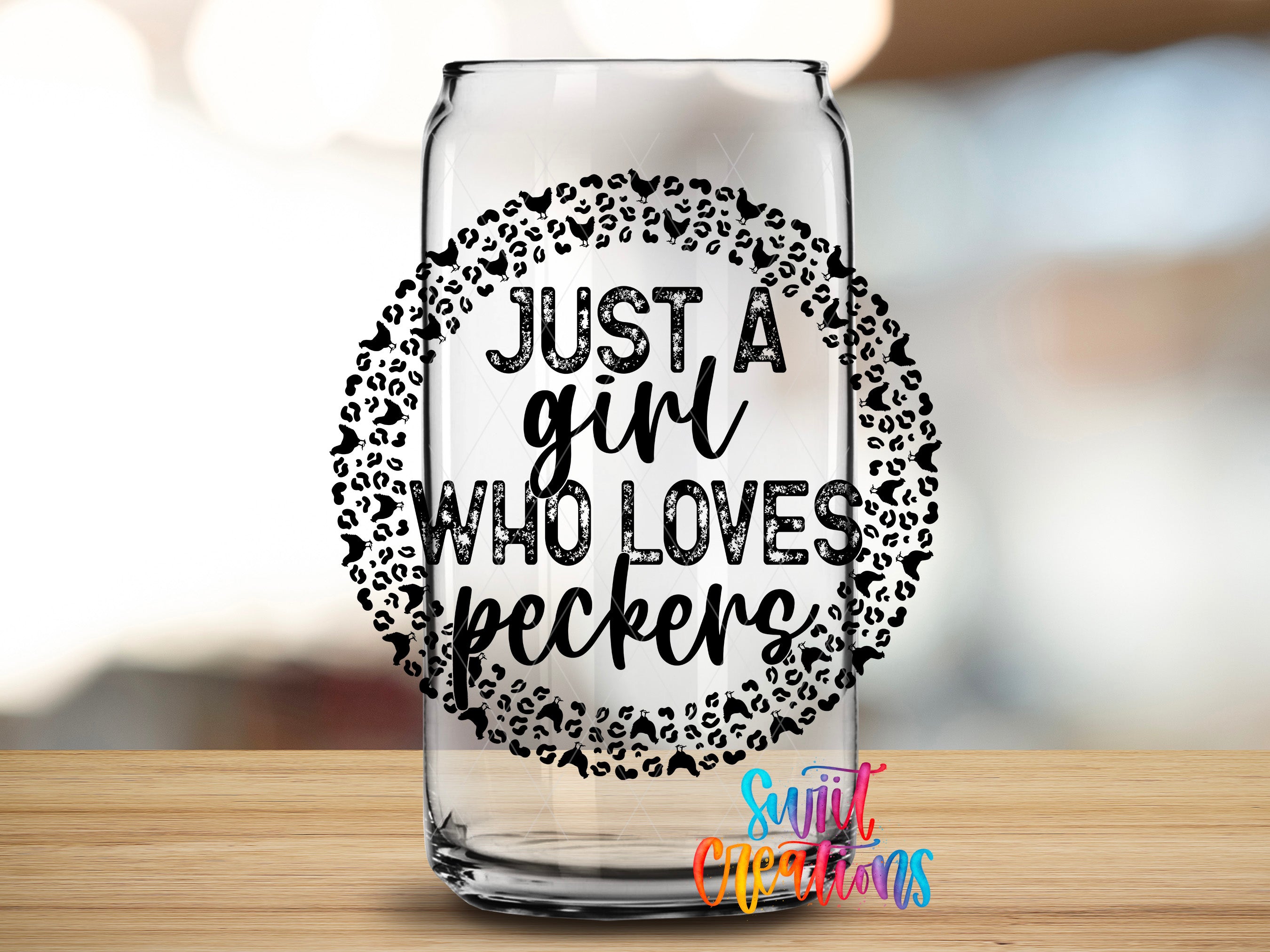A clear glass can with a decorative design around the rim, containing the text "JUST A GIRL WHO LOVES PECKERS" in a bold, stylized font.