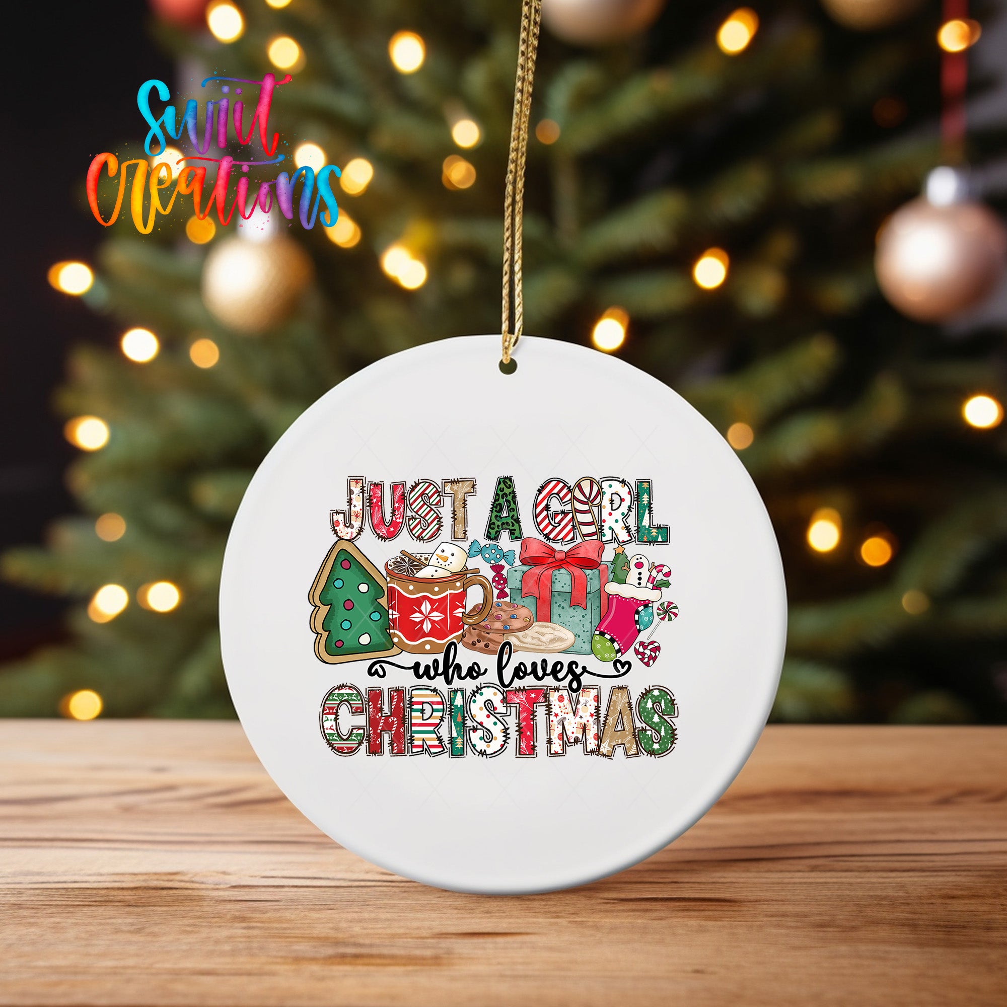 A white Christmas ornament with the text "Just a girl who loves Christmas" printed on it, hanging on a string.