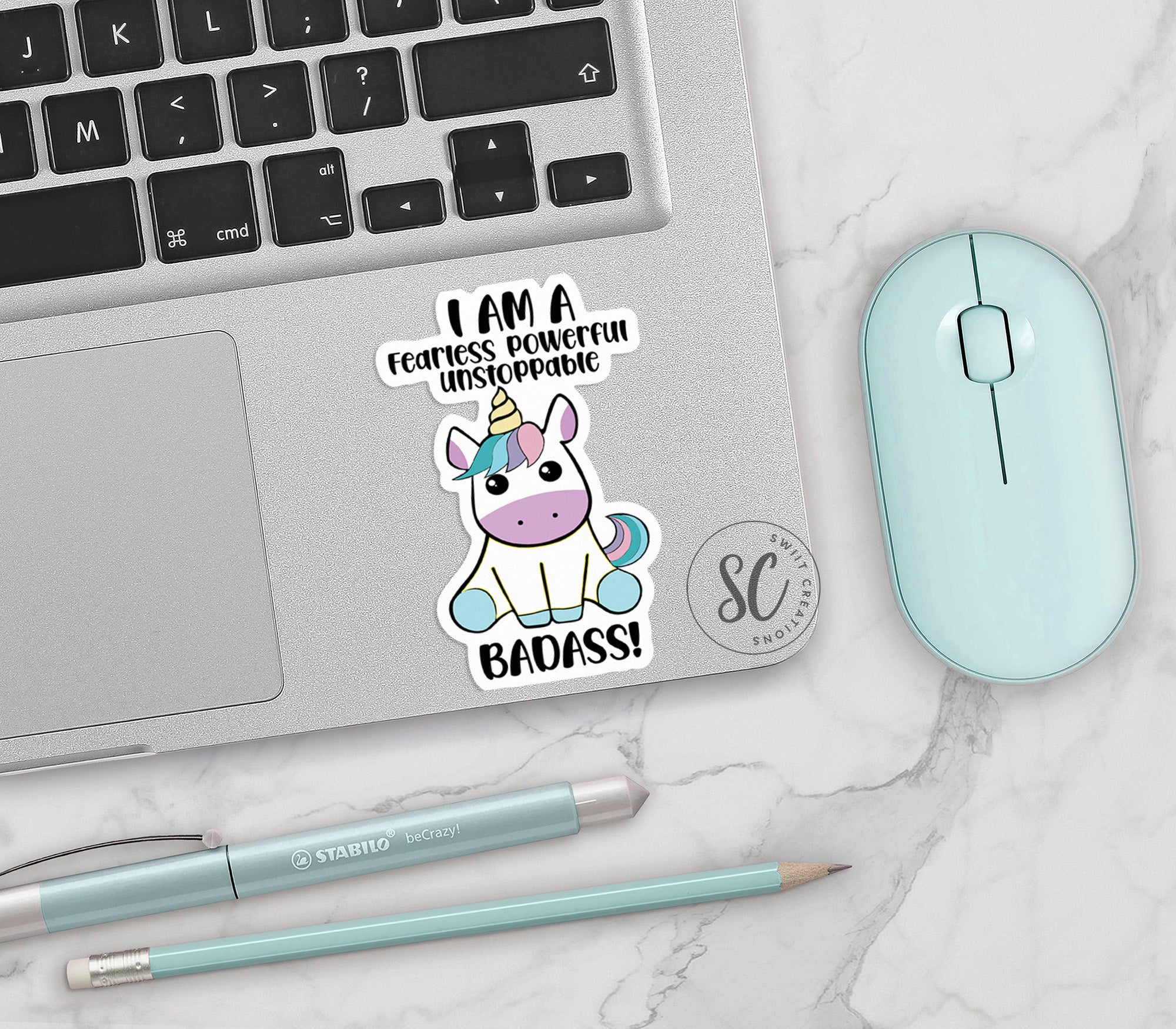 a laptop with a sticker of a unicorn on it