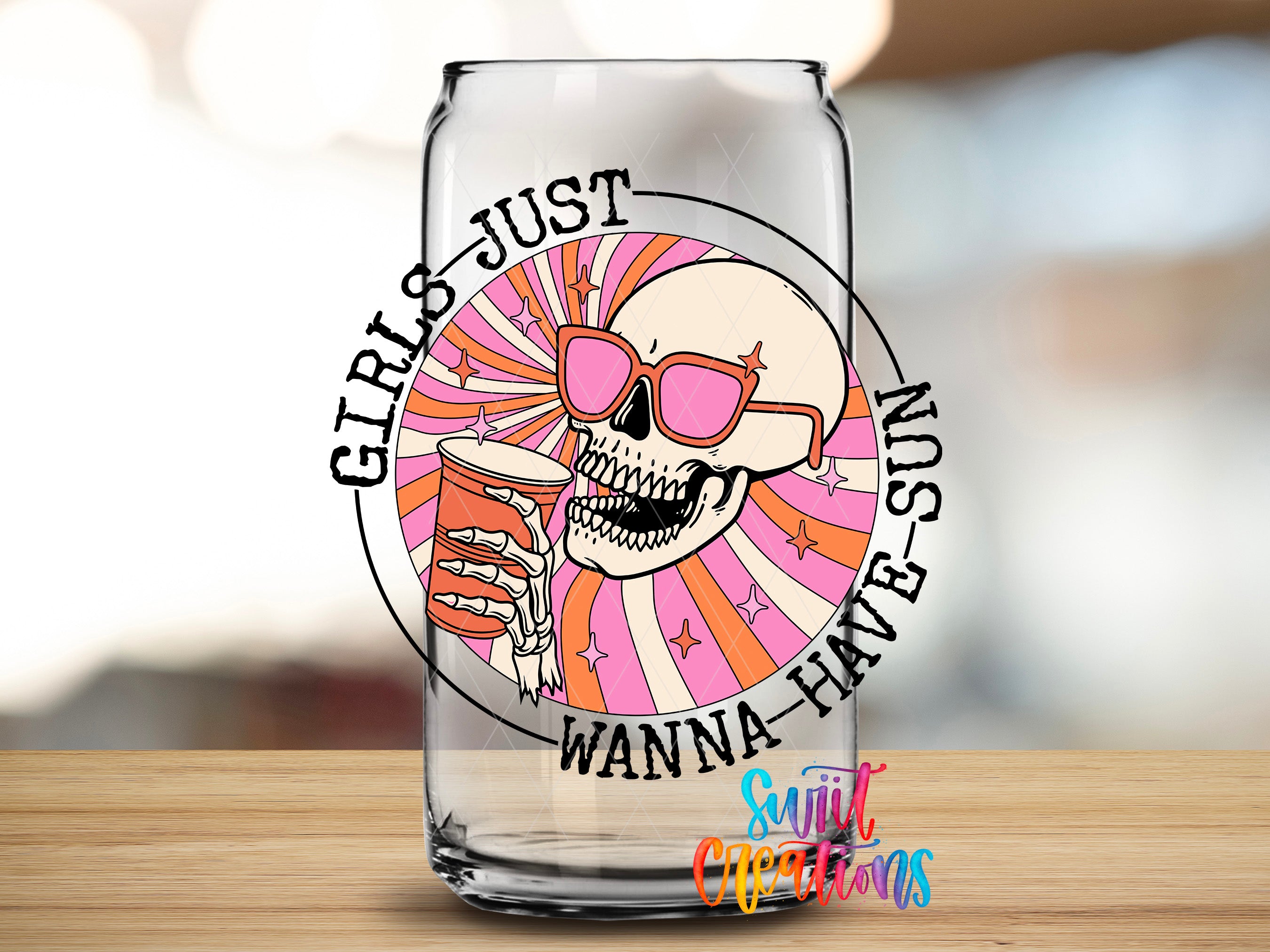 A glass can with a skull wearing sunglasses and holding a drink, surrounded by a circular design with the text "GIRLS JUST WANNA HAVE SUN"
