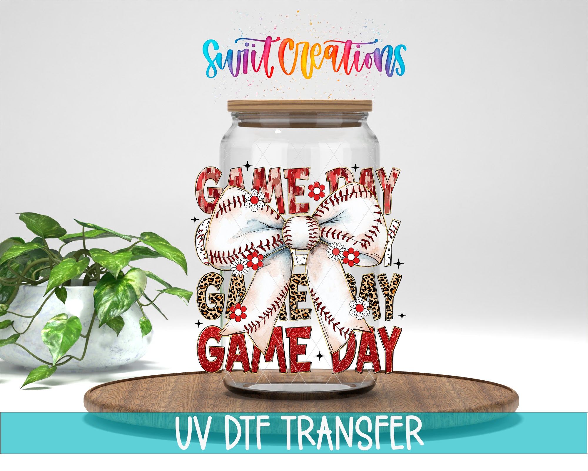 A glass jar with a baseball-themed design, including a baseball and a bow, is displayed on a wooden surface. The jar is labeled "GAME DAY" and "GAMES MY DAY". The background is white, and there is a potted plant to the left of the jar.