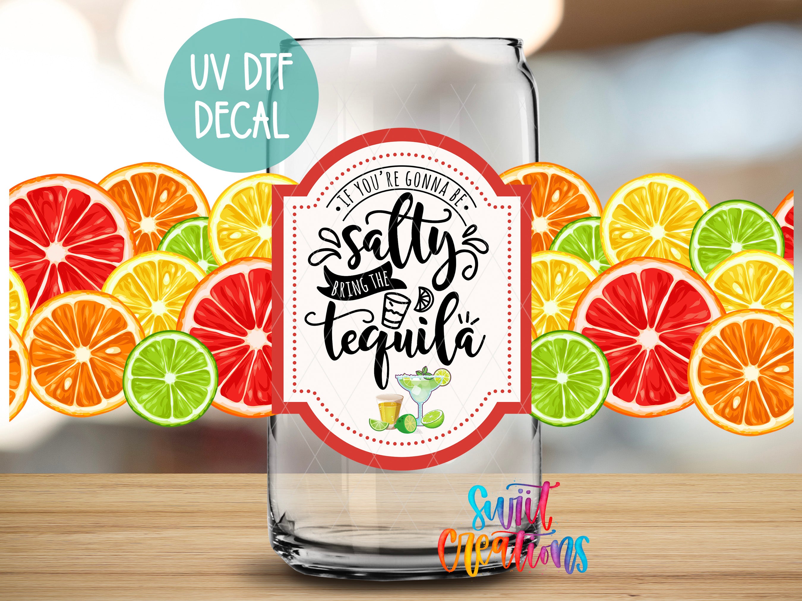 a clear glass jar with a label that says "If you're gonna be salty, bring the tequila" surrounded by colorful slices of citrus fruits.