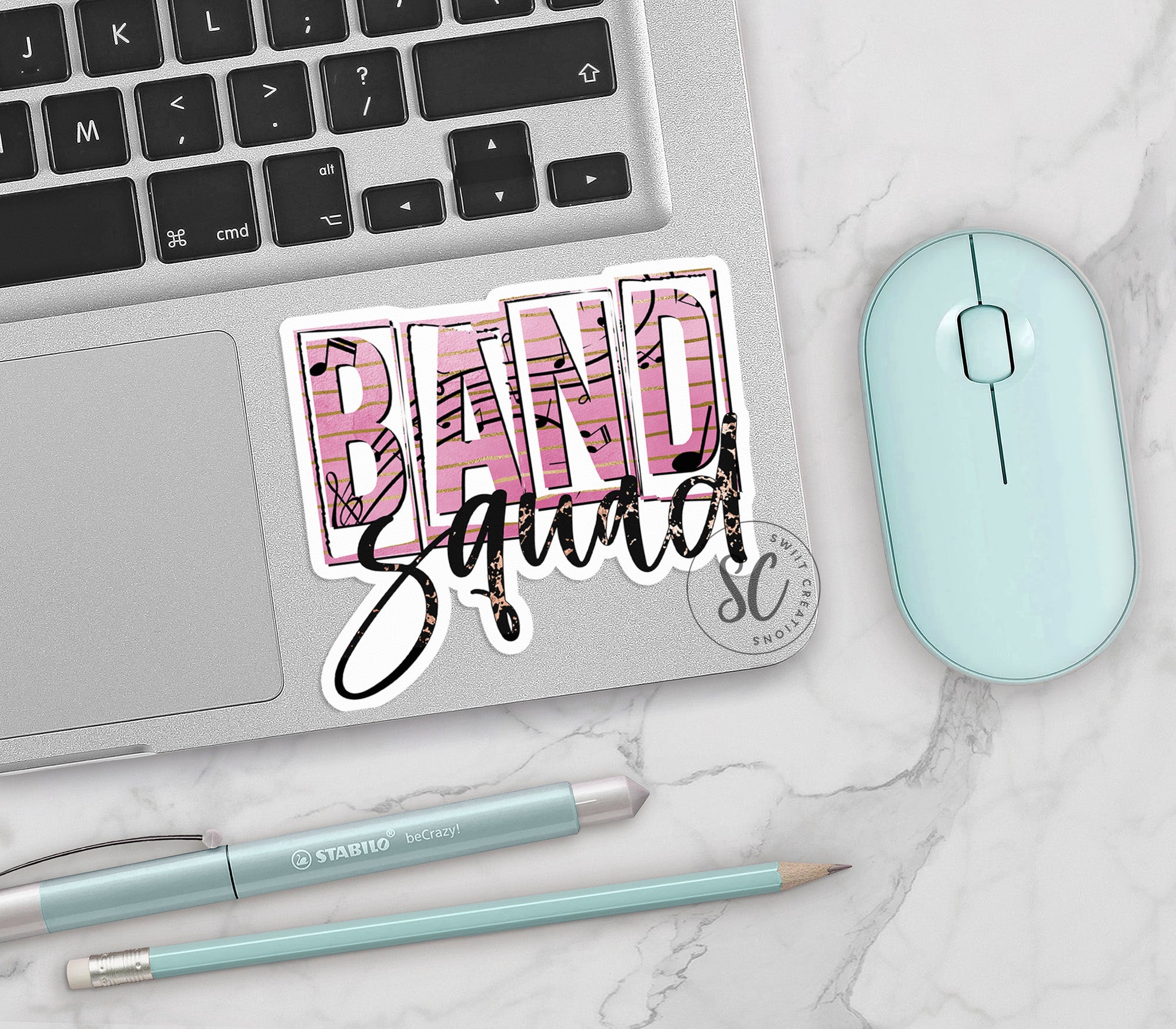 a computer keyboard, mouse, and sticker with the word band squad on it