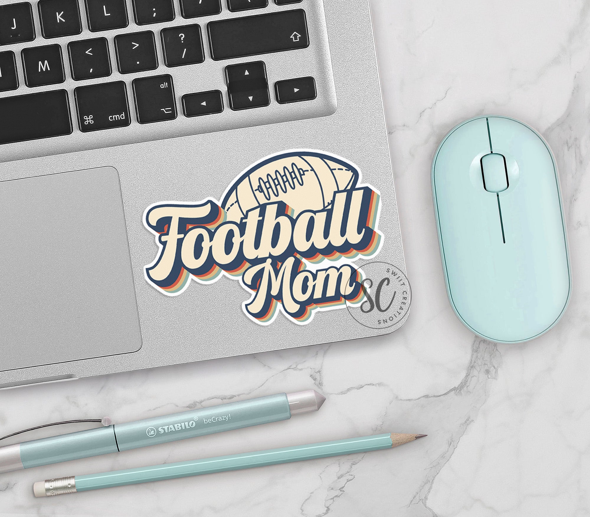 a laptop computer sitting on top of a white table