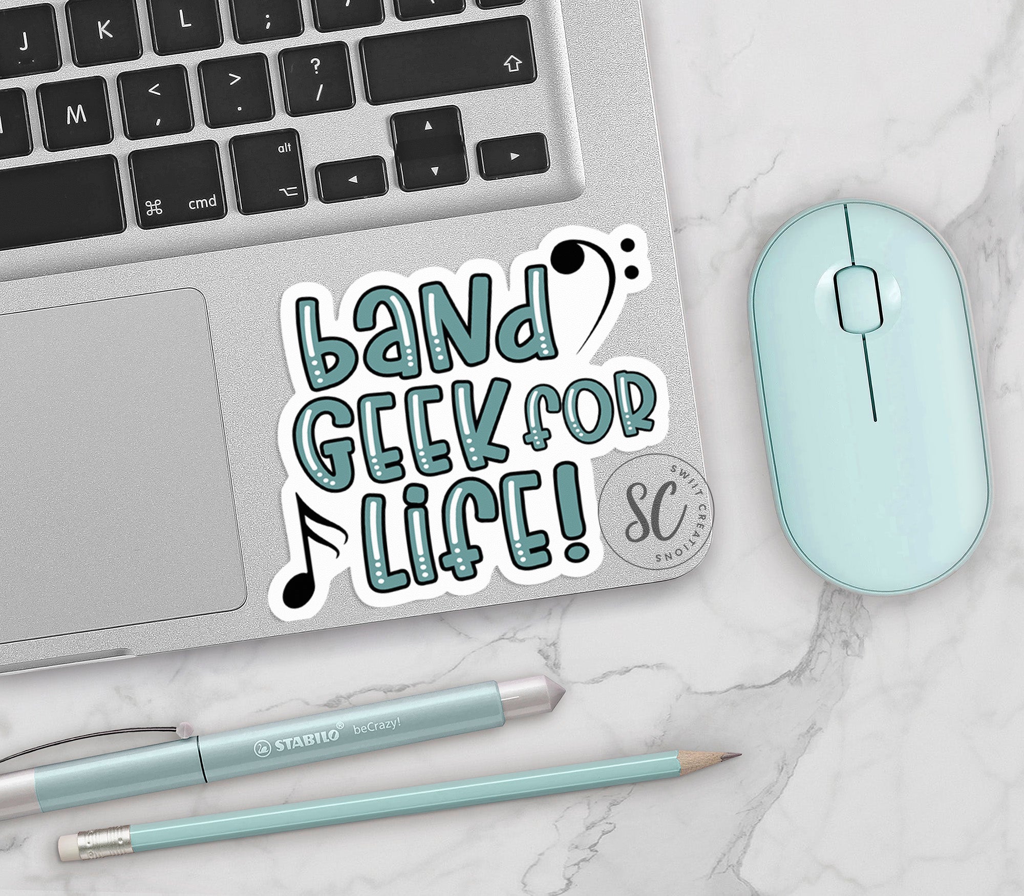 a keyboard, mouse, and sticker on a table