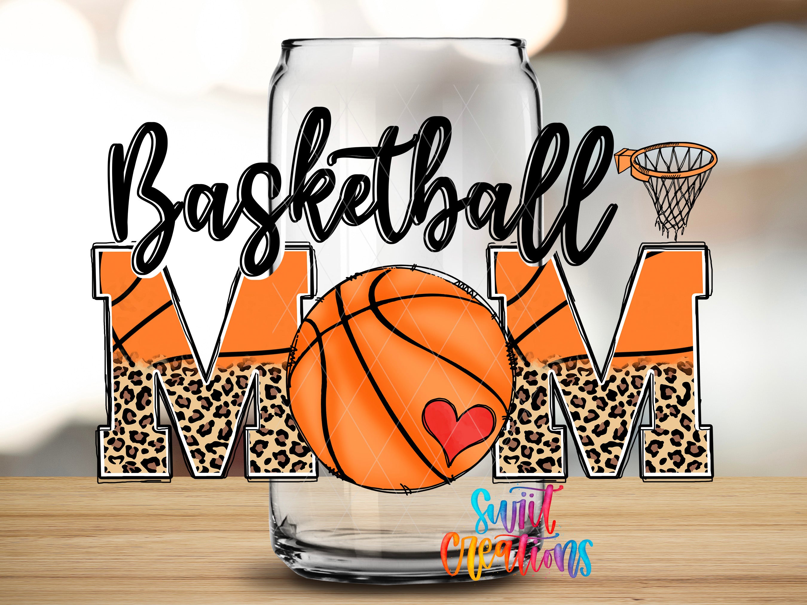 A glass can with the word "Basket Ball Mom" written on it, along with a basketball graphic and leopard print lettering.