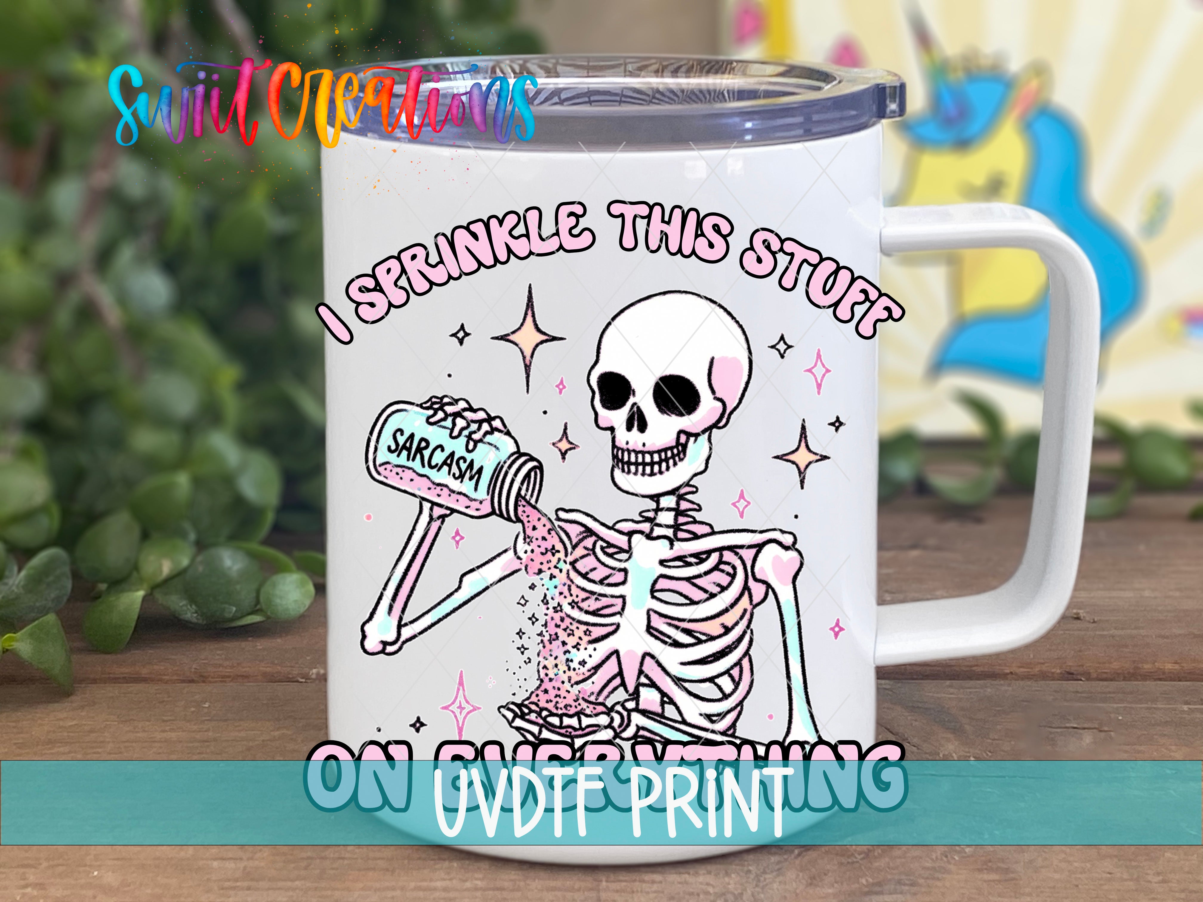 A white mug with a cartoon skeleton holding a jar of "Sarcasm" and the text "I sprinkle this stuff" printed on it.