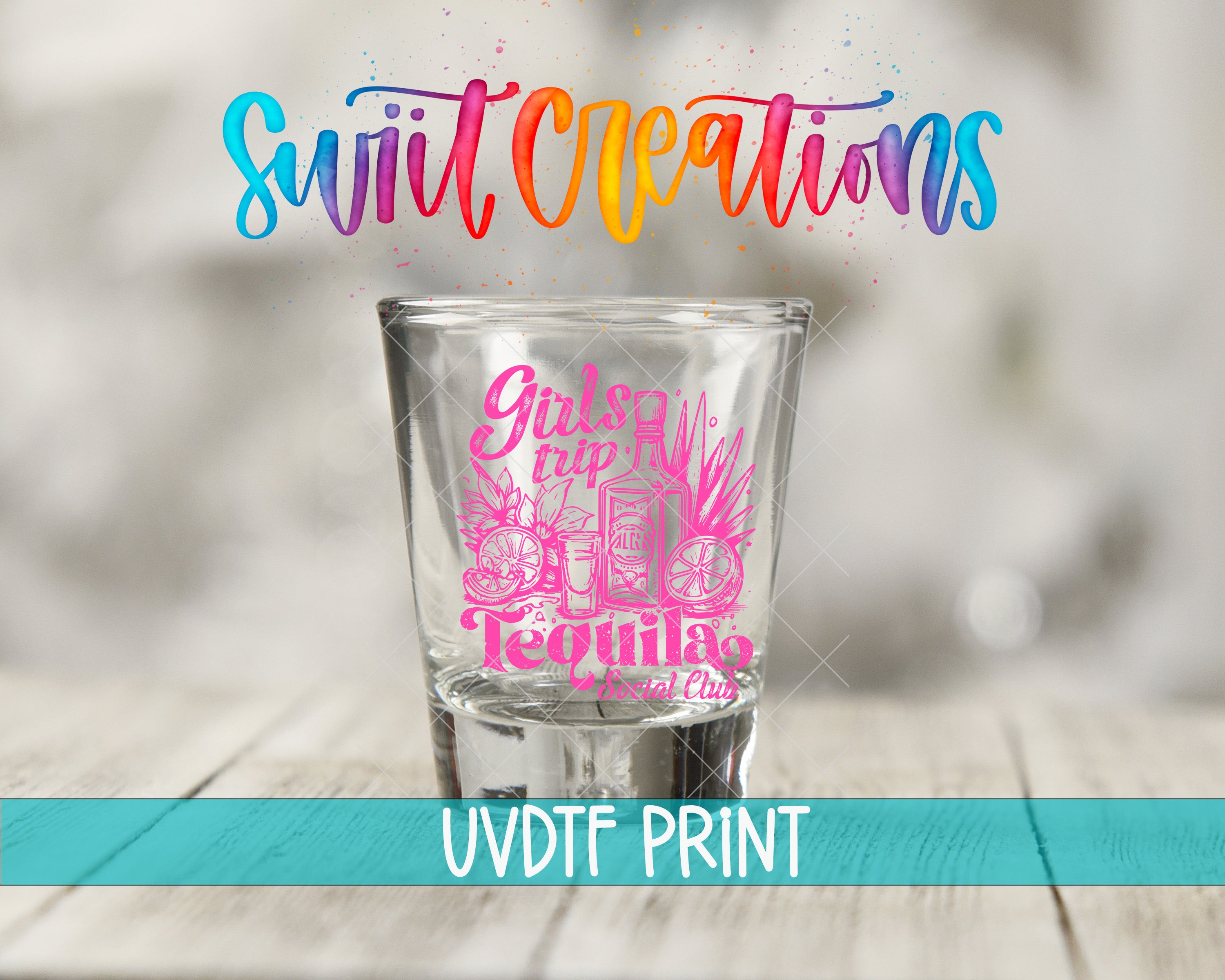 A shot glass with a colorful design and text printed on it, placed on a wooden surface.