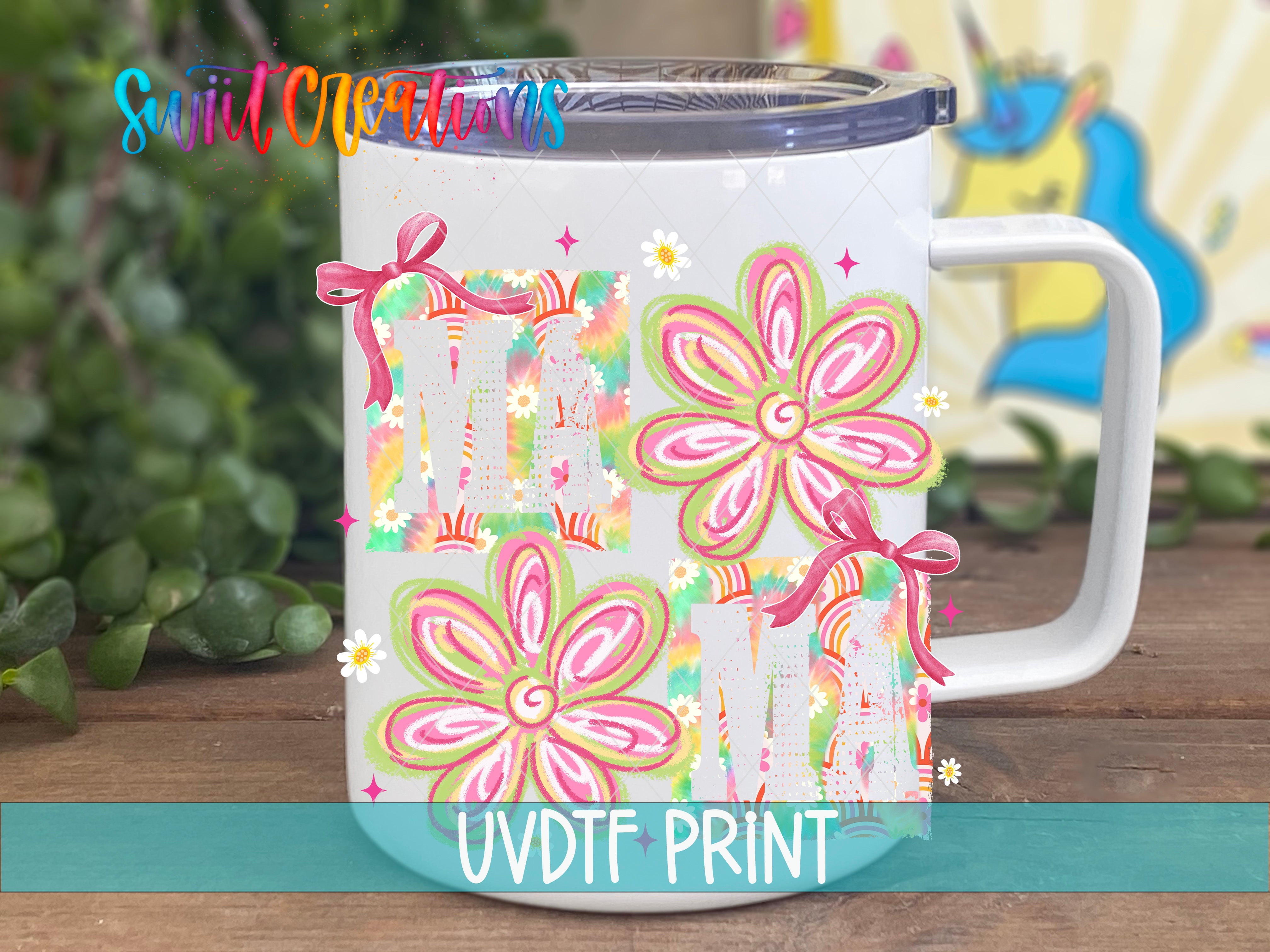 A white ceramic mug with colorful floral designs and bows on it, placed on a wooden surface.