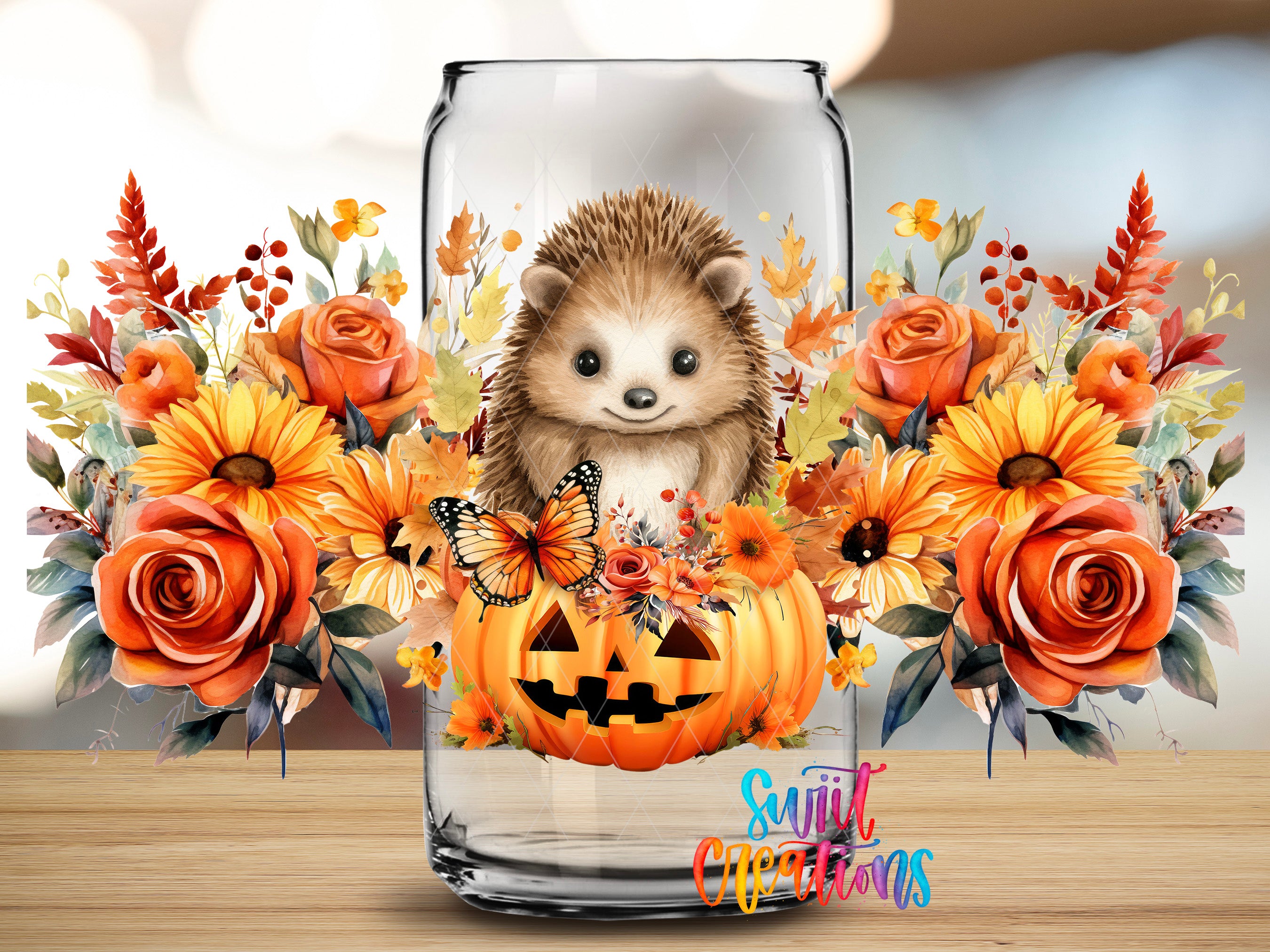 A glass vase filled with a variety of autumn flowers, including sunflowers, roses, and a pumpkin, along with a hedgehog and butterflies.