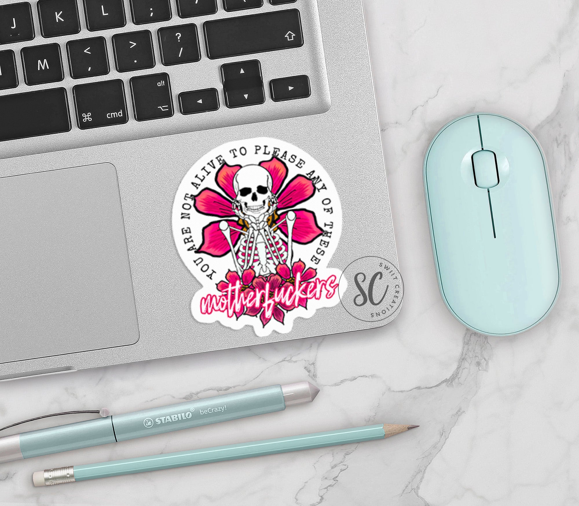 a laptop computer sitting next to a mouse and keyboard