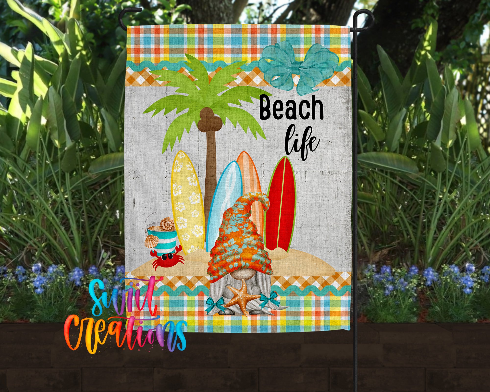 A colorful beach-themed garden flag featuring a palm tree, surfboards, and a gnome, with the text "Beach life" displayed.