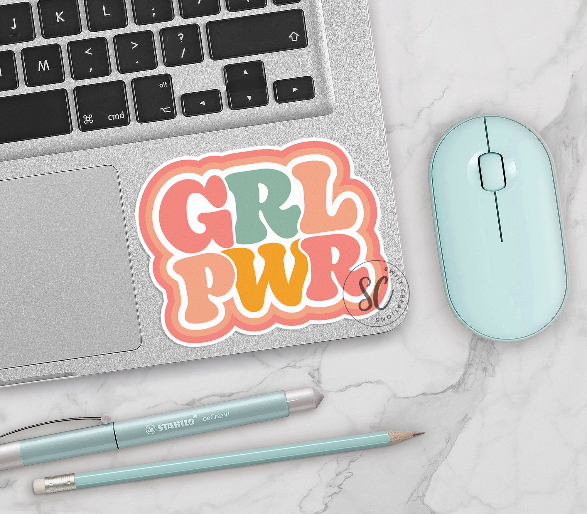 a laptop with a sticker of the word girl power on it