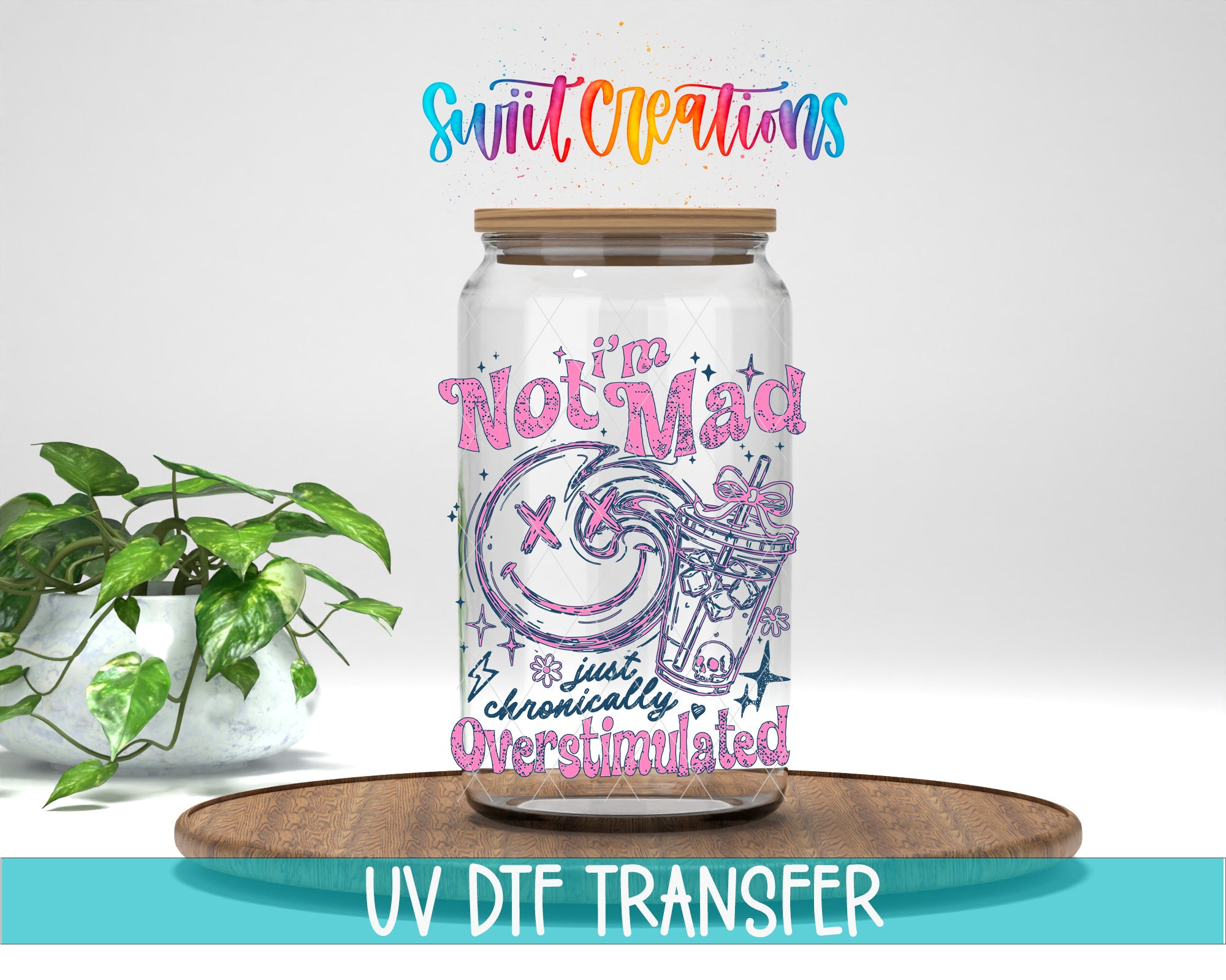 a glass jar with a colorful design and text on it, placed on a wooden surface. There is a potted plant in the background, and the image includes text that says "Swit Creations" and "I'm Not Mad" along with the phrase "just chronically overstimulated".