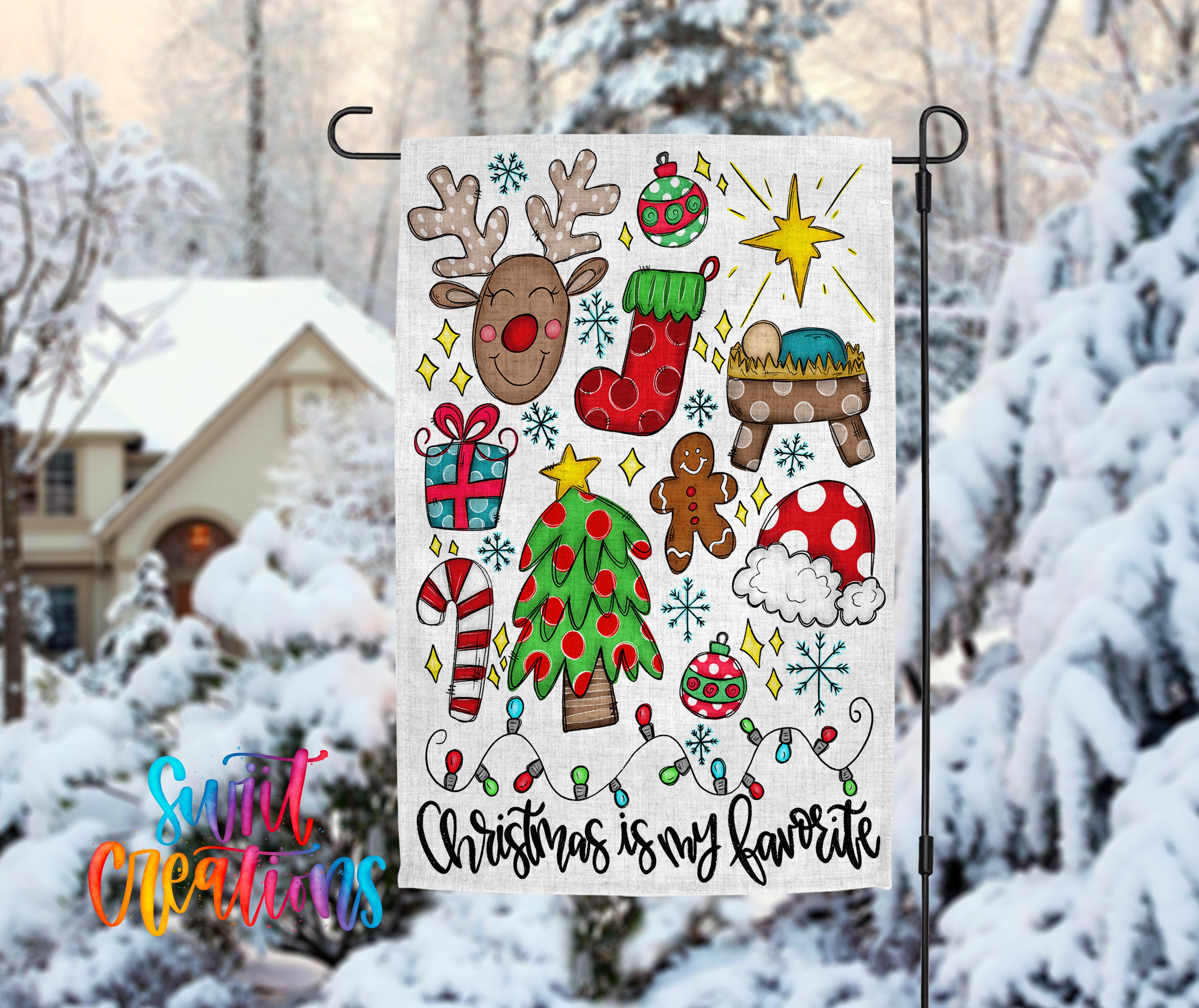 A colorful Christmas-themed flag is displayed in the foreground, featuring various holiday decorations such as a reindeer, stockings, a nativity scene, a Christmas tree, and other festive elements. The background shows a snowy landscape with a house and trees covered in snow.