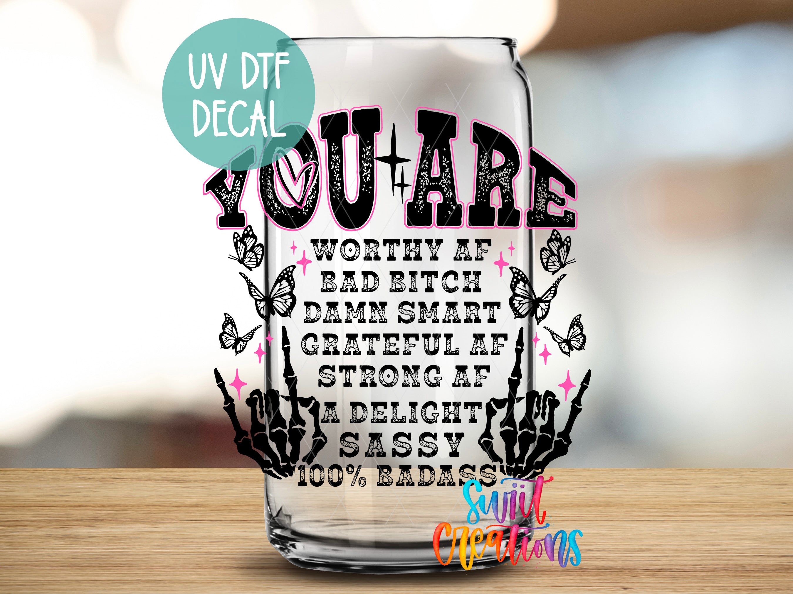 a glass with a quote on it sitting on a table