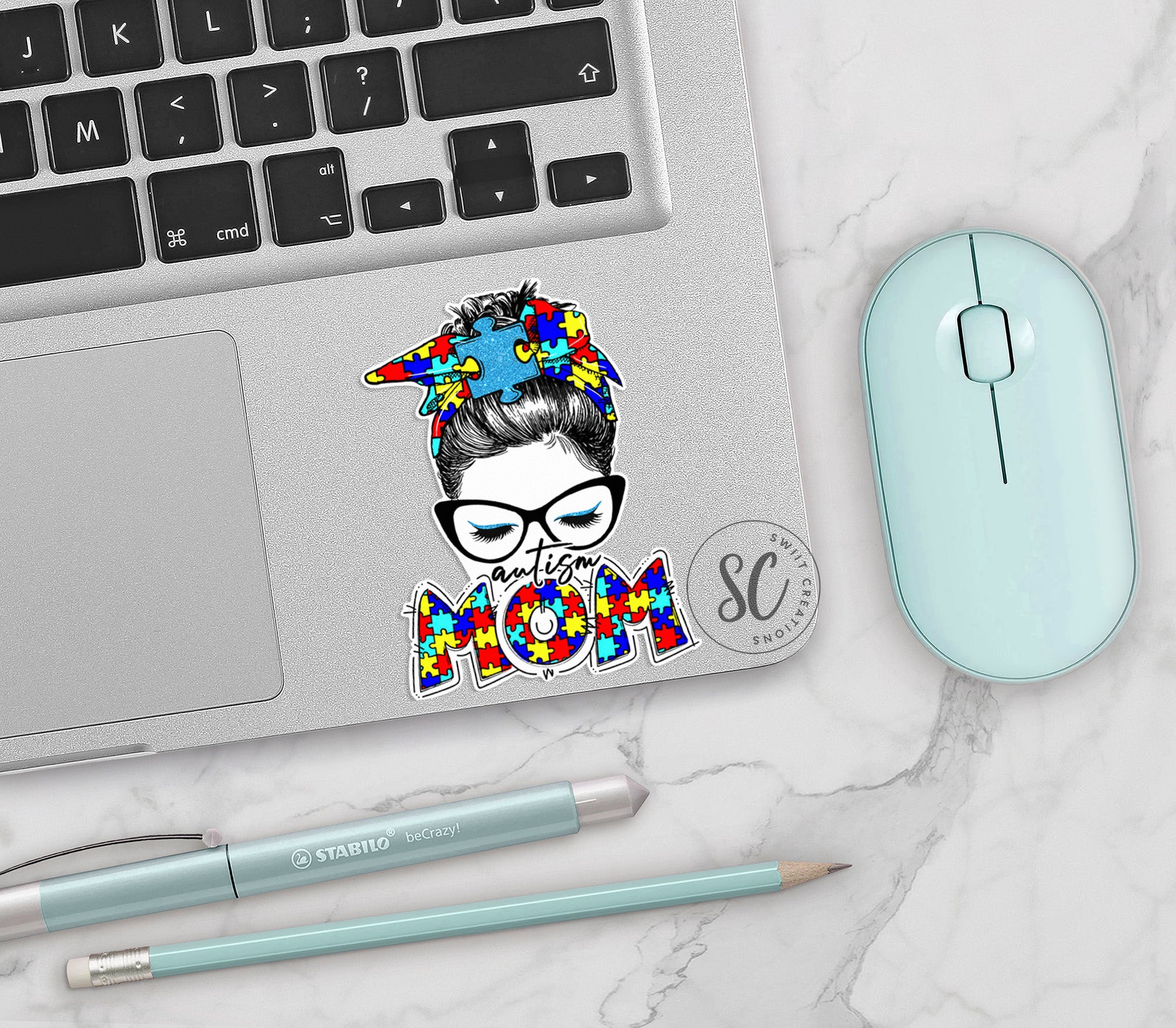 a laptop with a sticker of a woman's head on it