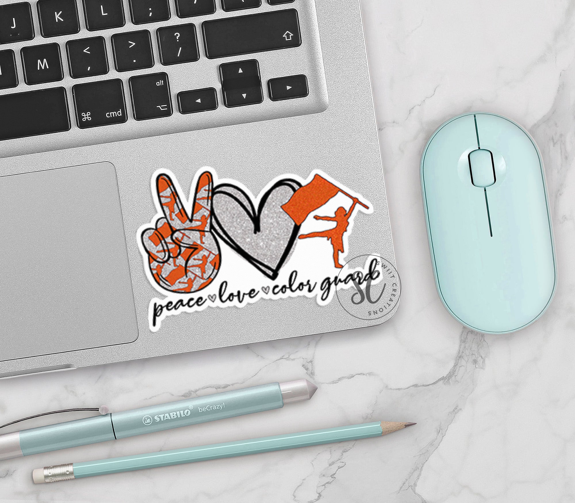 a laptop with a sticker of a hand and a heart