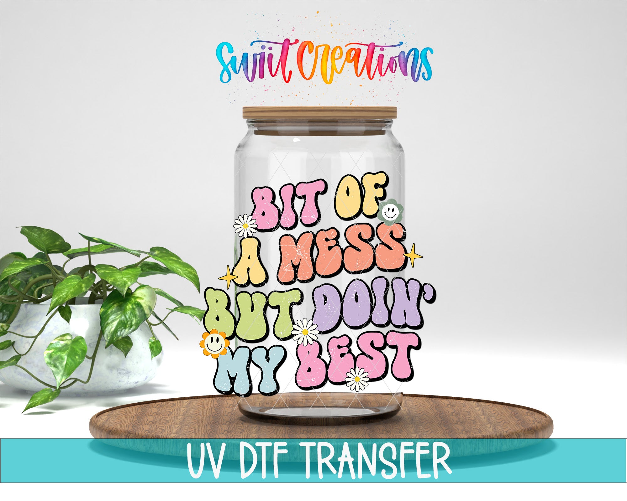 A colorful jar with a lid, featuring a whimsical text design that says "BIT OF A MESS BUT DOIN' MY BEST" along with various decorative elements such as smiley faces and flowers. The jar is placed on a wooden surface, and there is a potted plant in the background.