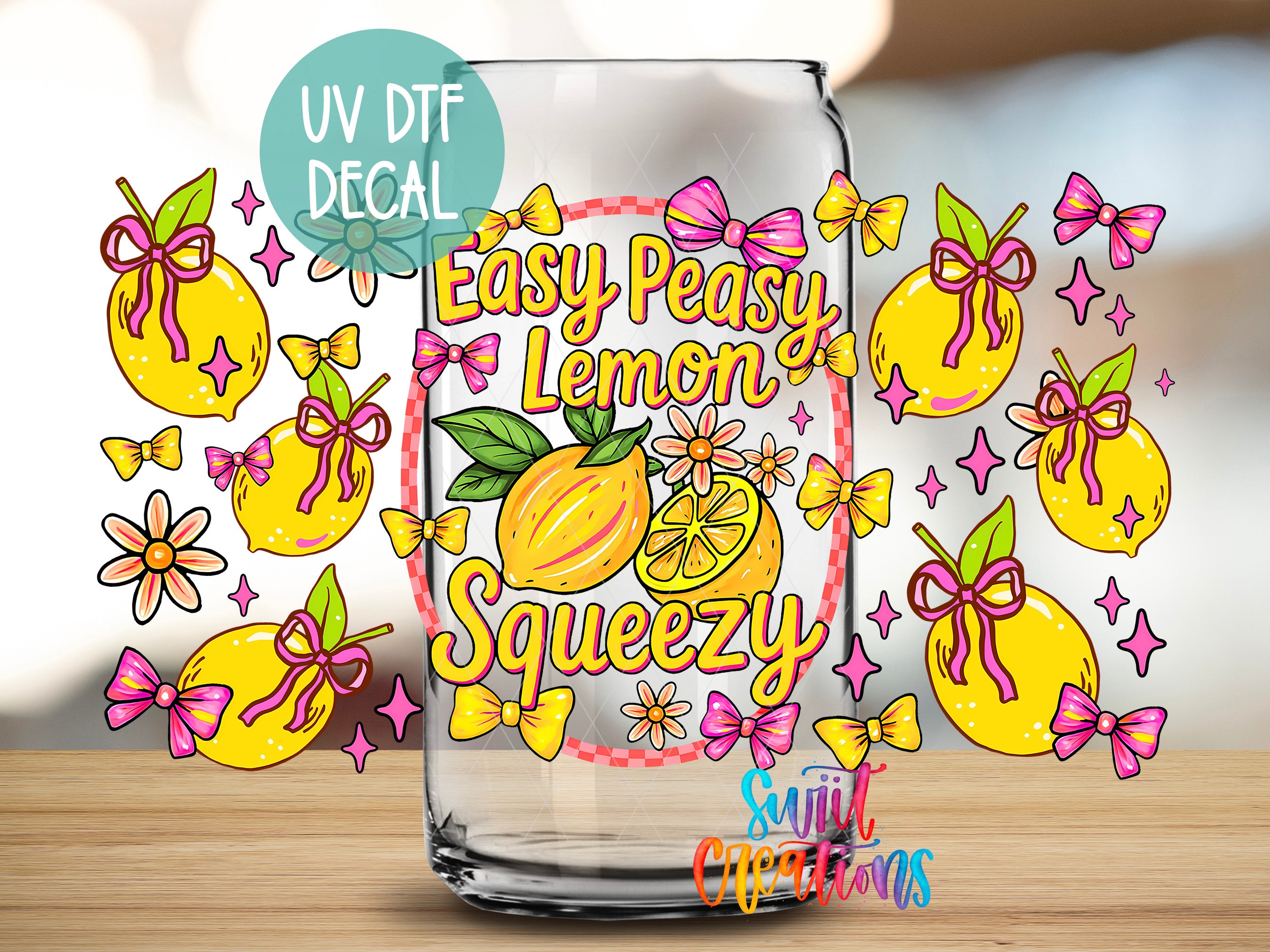 a glass with a decorative design, including illustrations of lemons, flowers, and bows.