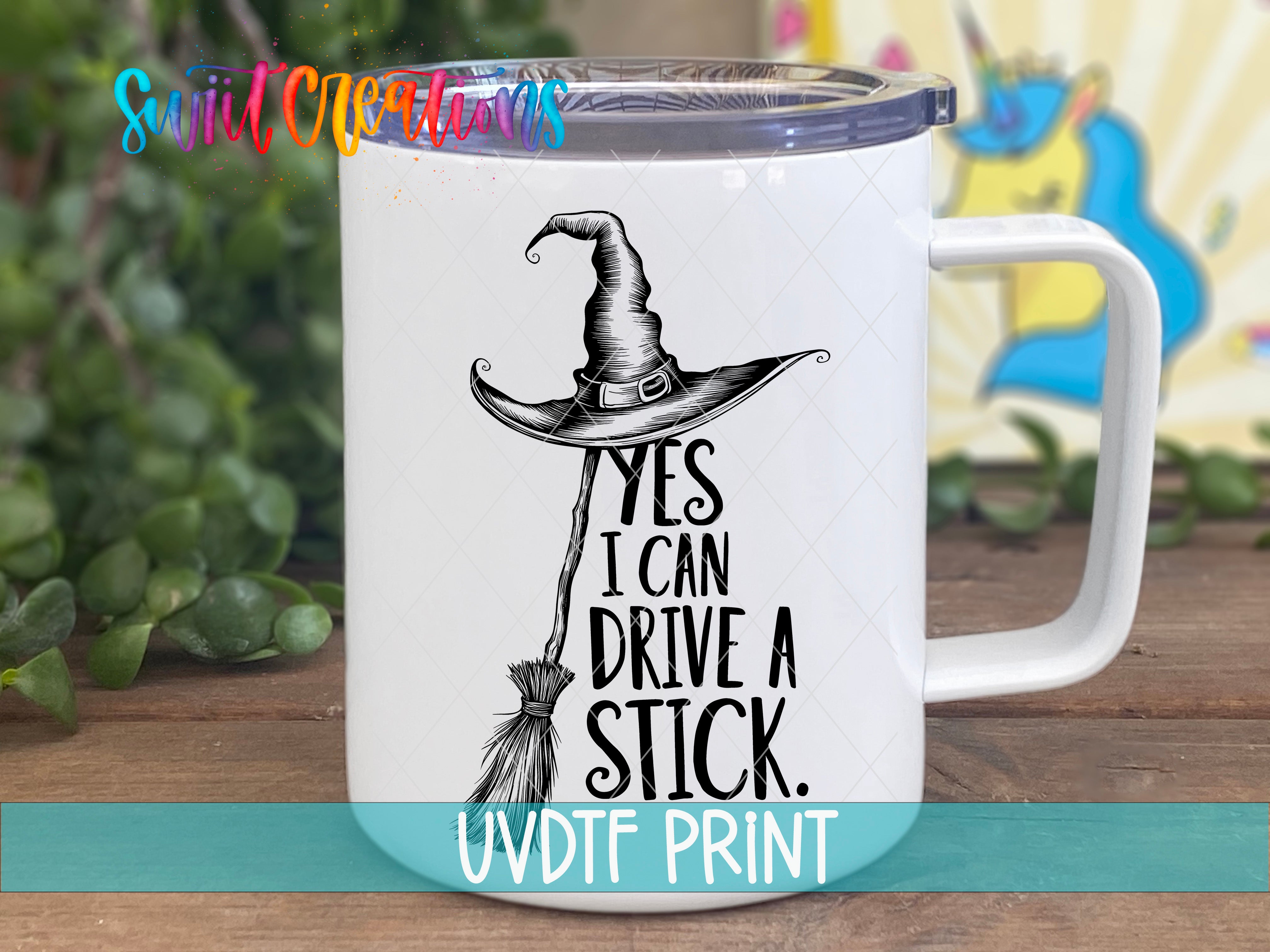 A mug with a witch's hat and the text "YES I CAN DRIVE A STICK" printed on it.