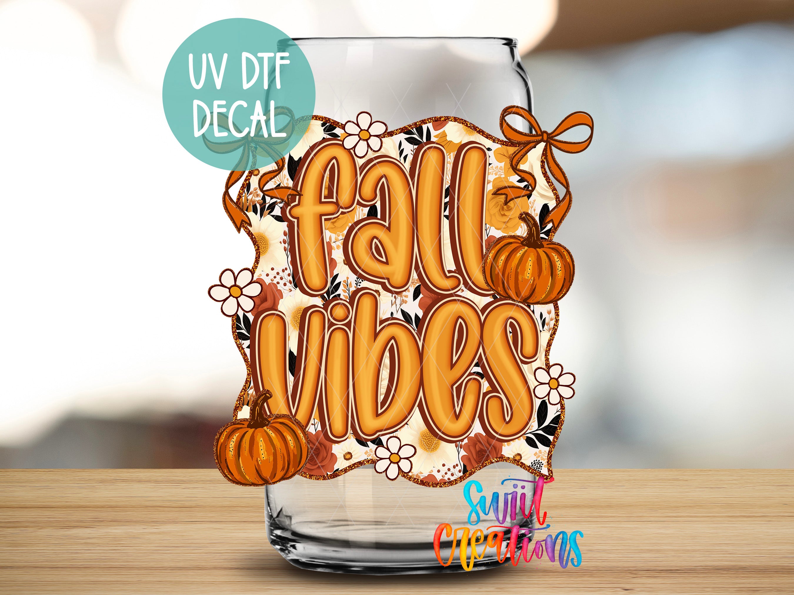a glass with a decorative fall-themed decal on it, including a pumpkin and flowers.