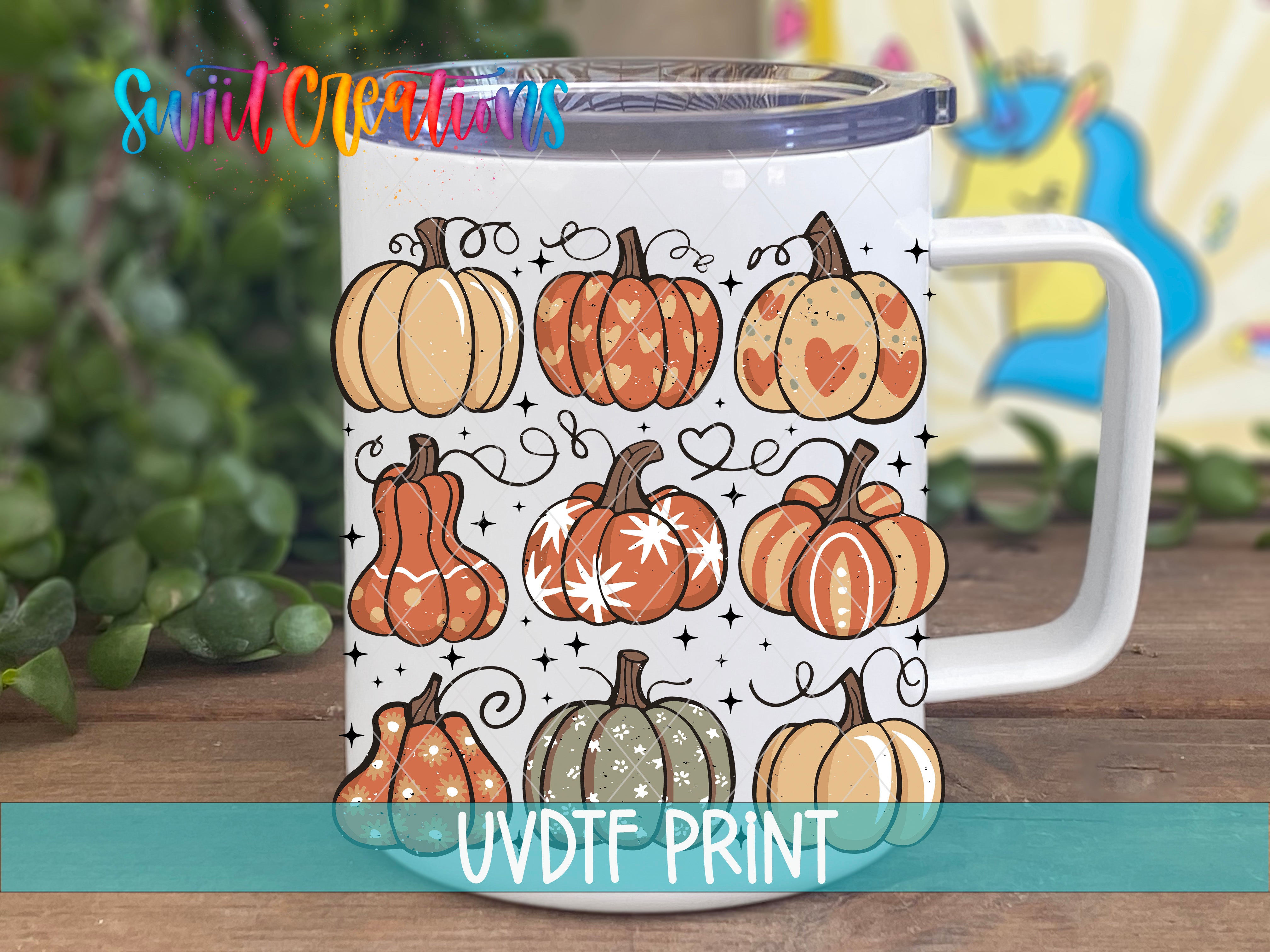 A white mug with a printed design of various pumpkins and stars on it.