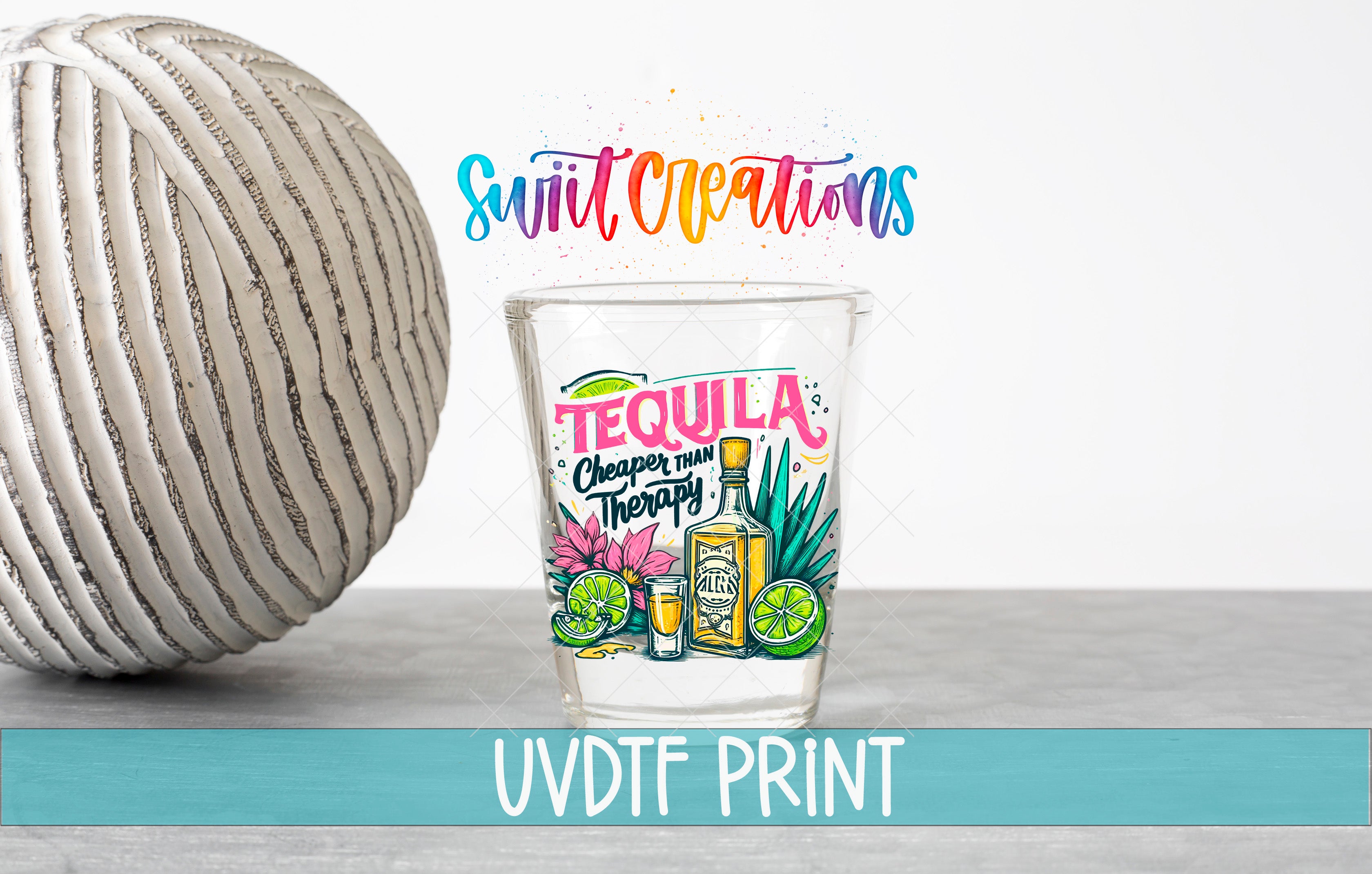 a tequila-themed glass with a colorful design, placed next to a white ball and a text that reads "Swift Creations".