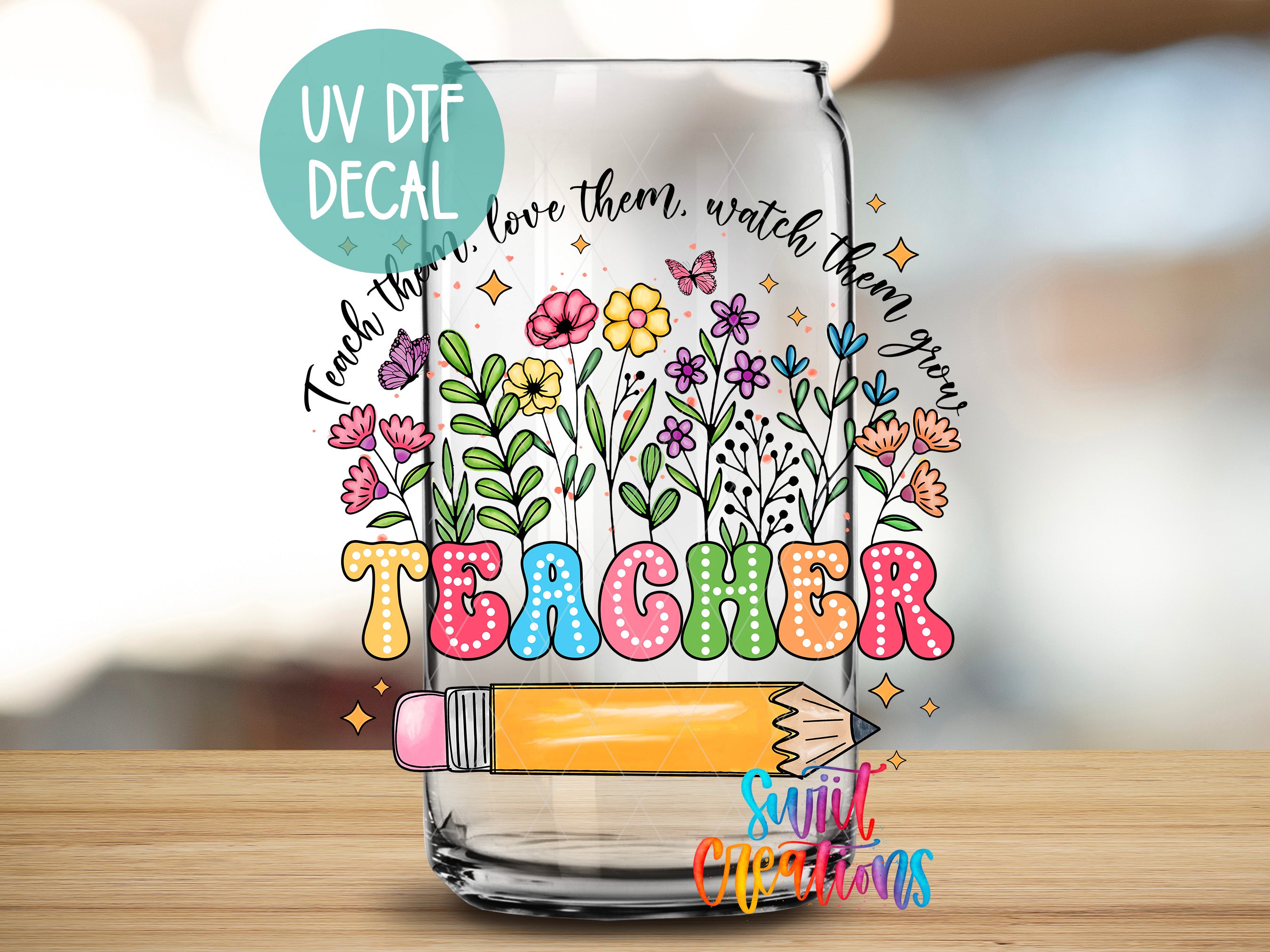 a clear glass with a drawing of flowers and a pencil