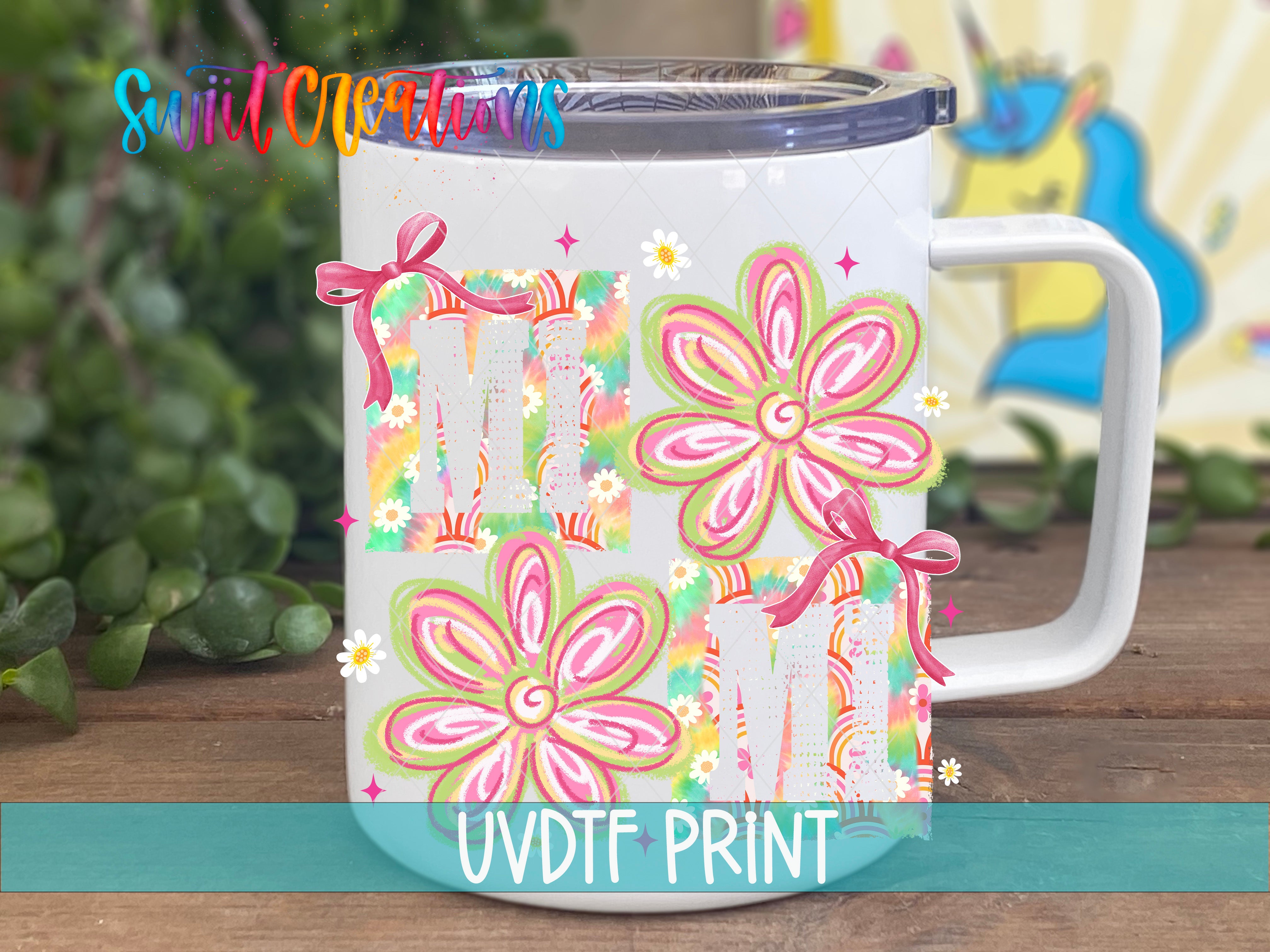 A white ceramic mug with colorful floral designs and the text "UVDF PRINT" printed on it.