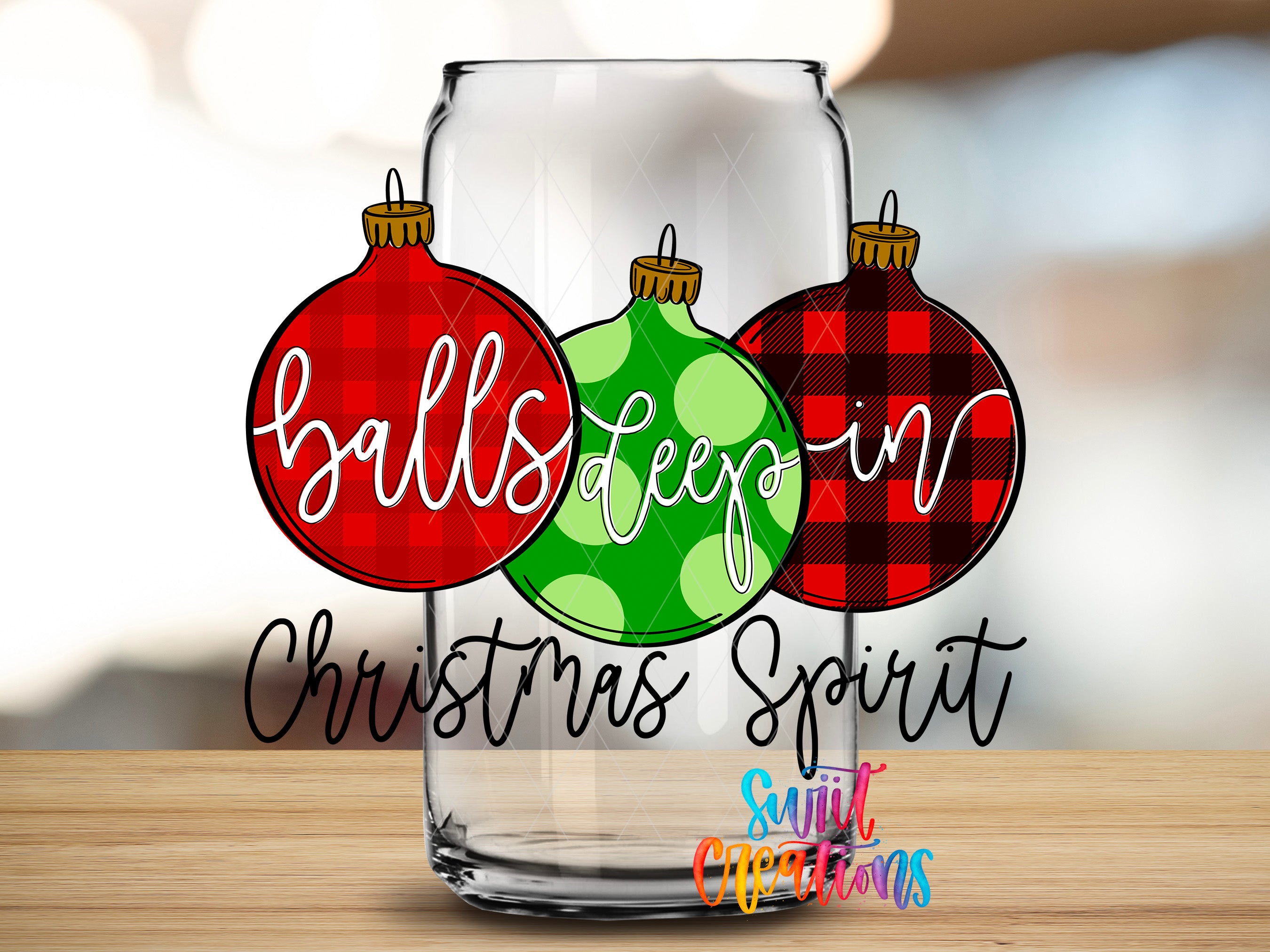 A glass can with three Christmas ornaments, each with a different color and pattern, arranged in a row. The text "balls deep in Christmas Spirit" is written below the ornaments.