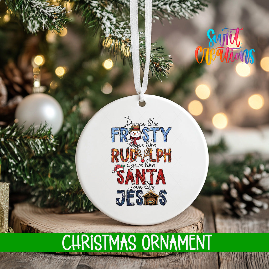 A white Christmas ornament with text that says "Dance like the FROSTY RUMPH gives like a RULPH like a SANTA like JESUS" is hanging on a Christmas tree.