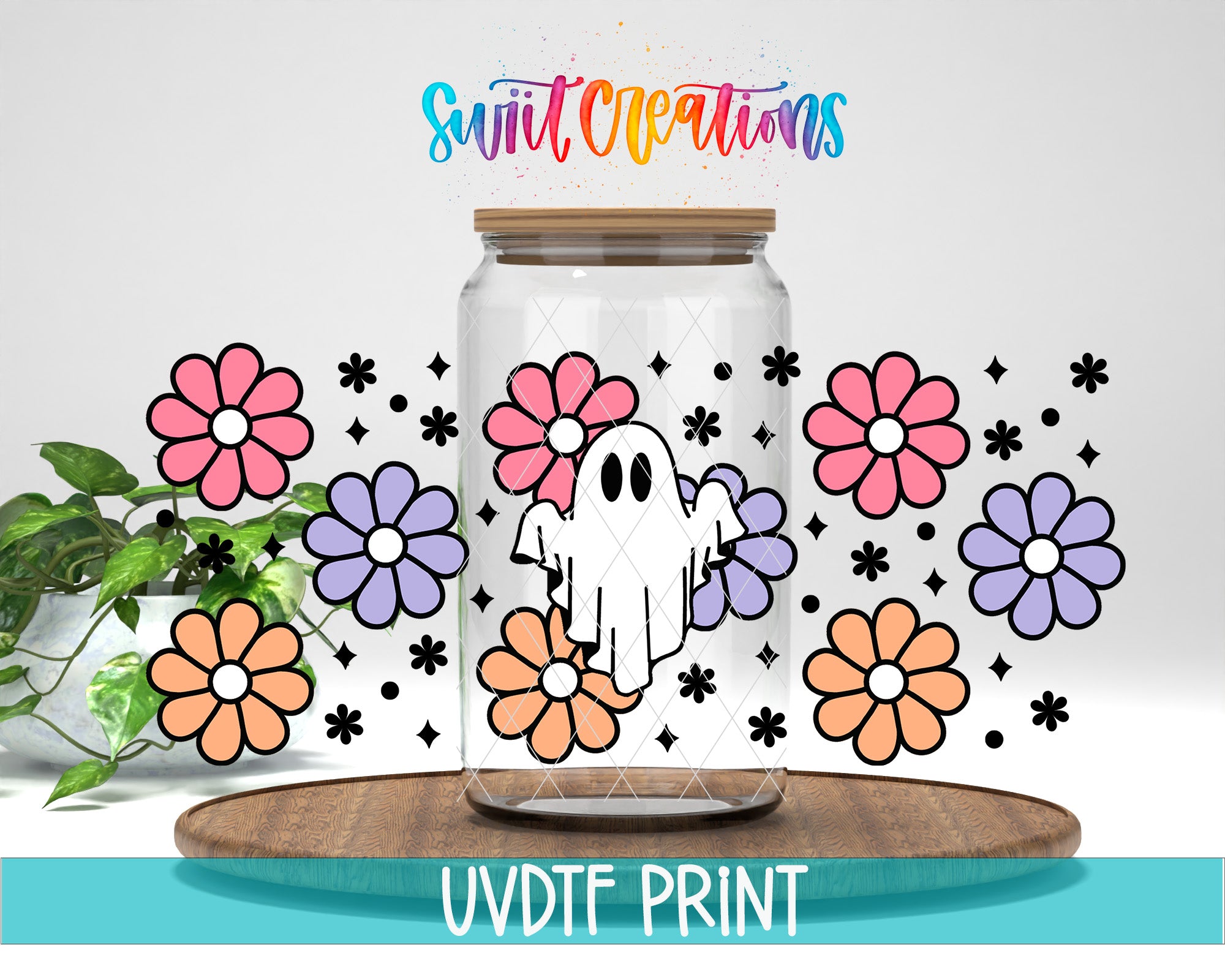 a glass jar with a ghost and colorful flowers surrounding it, placed on a wooden surface.