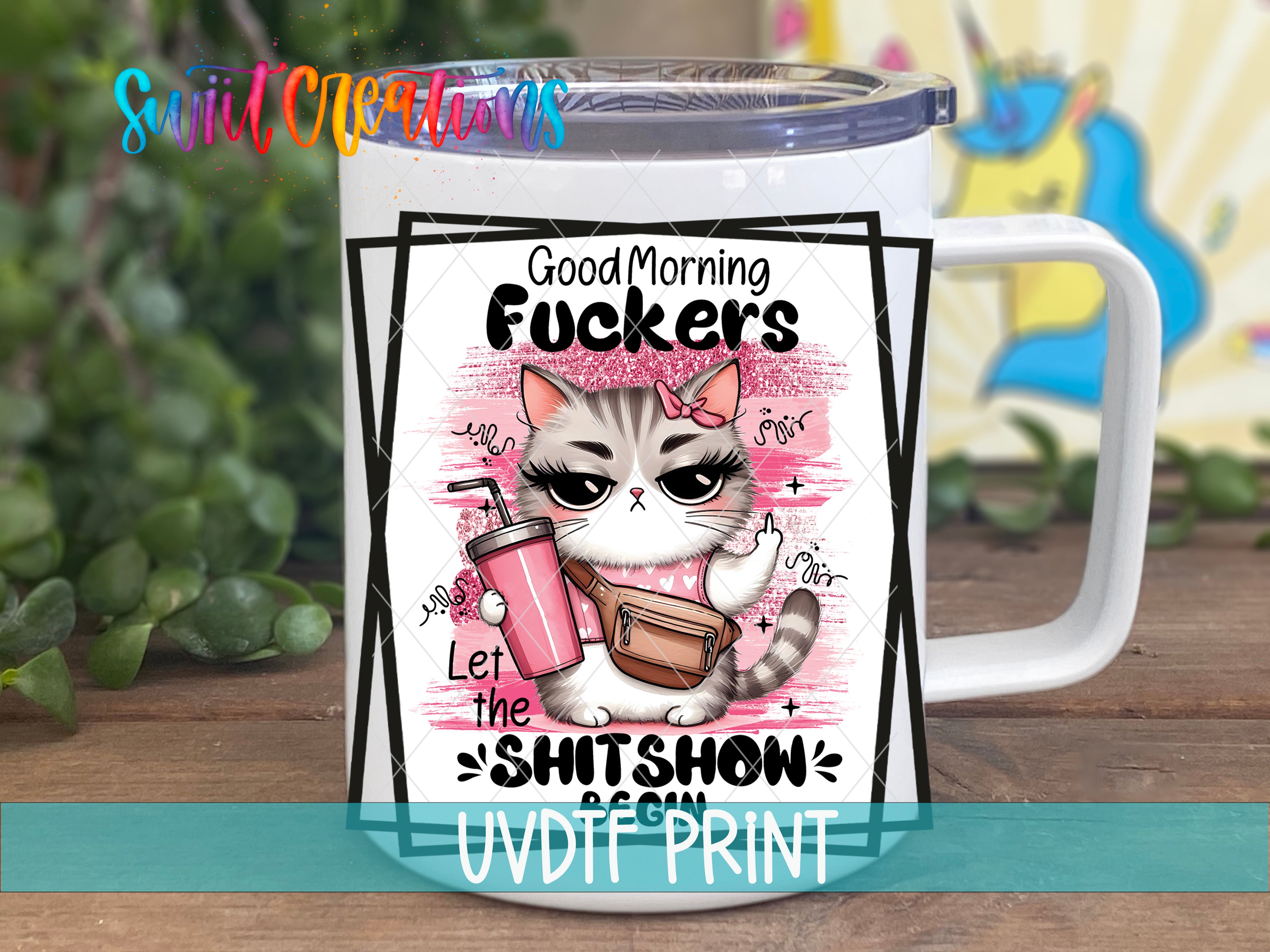 A white mug with a cartoon cat design and text printed on it.