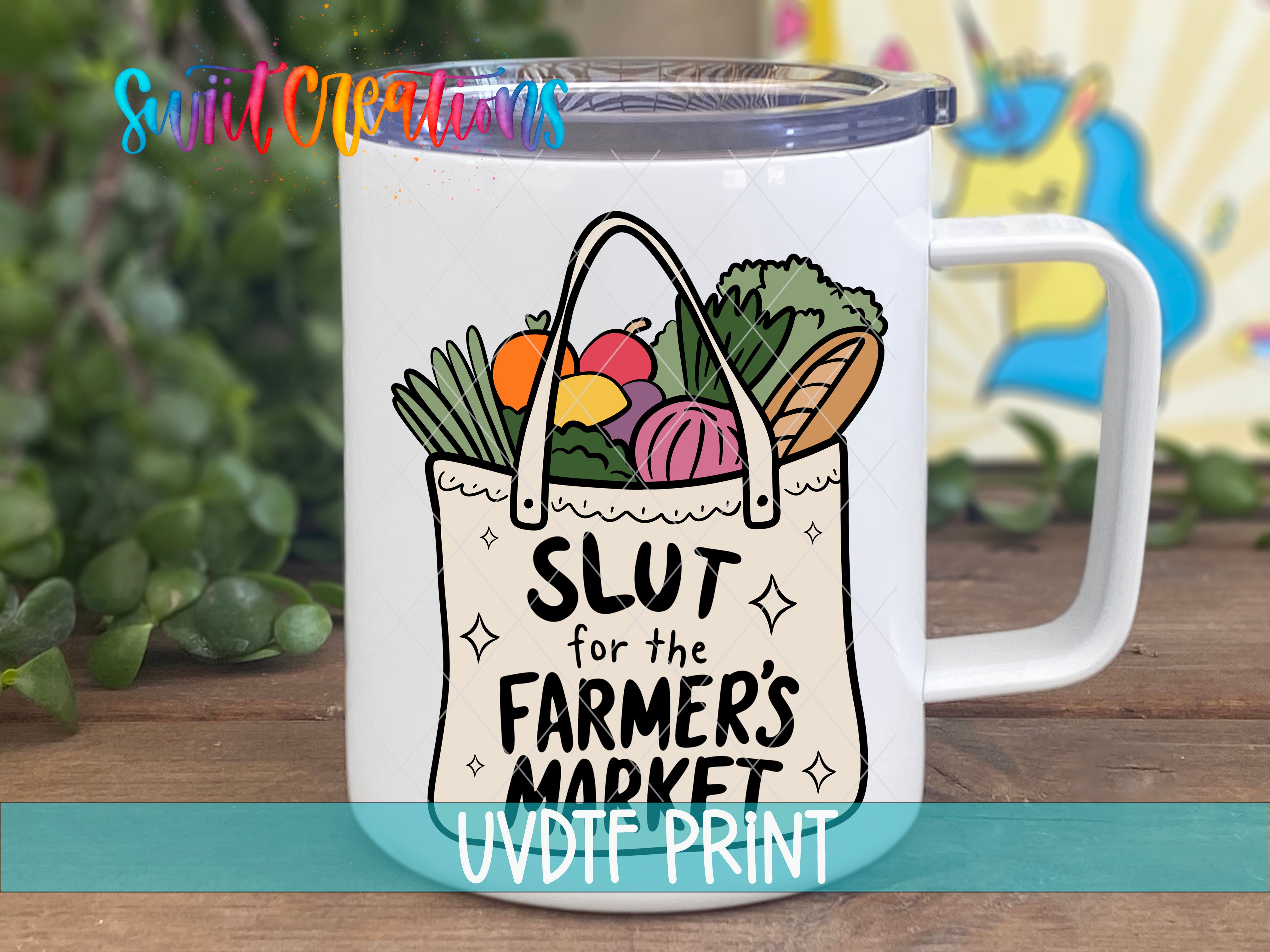A white mug with a colorful illustration of a bag filled with various fruits and vegetables, along with the text "SLUT for the FARMER'S MARKET" printed on it.