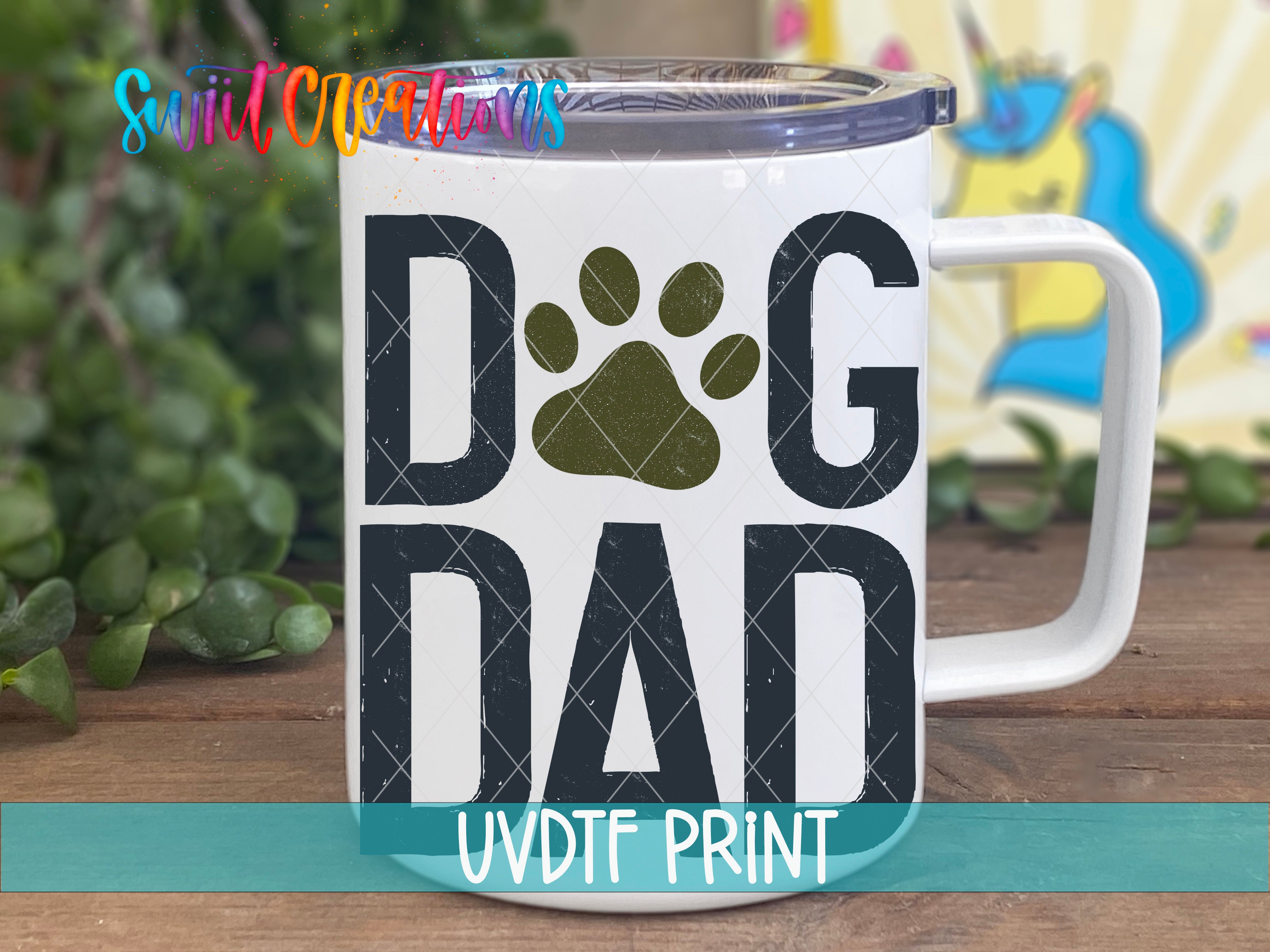 A white mug with the text "DOG DAD" printed on it, along with a paw print design.