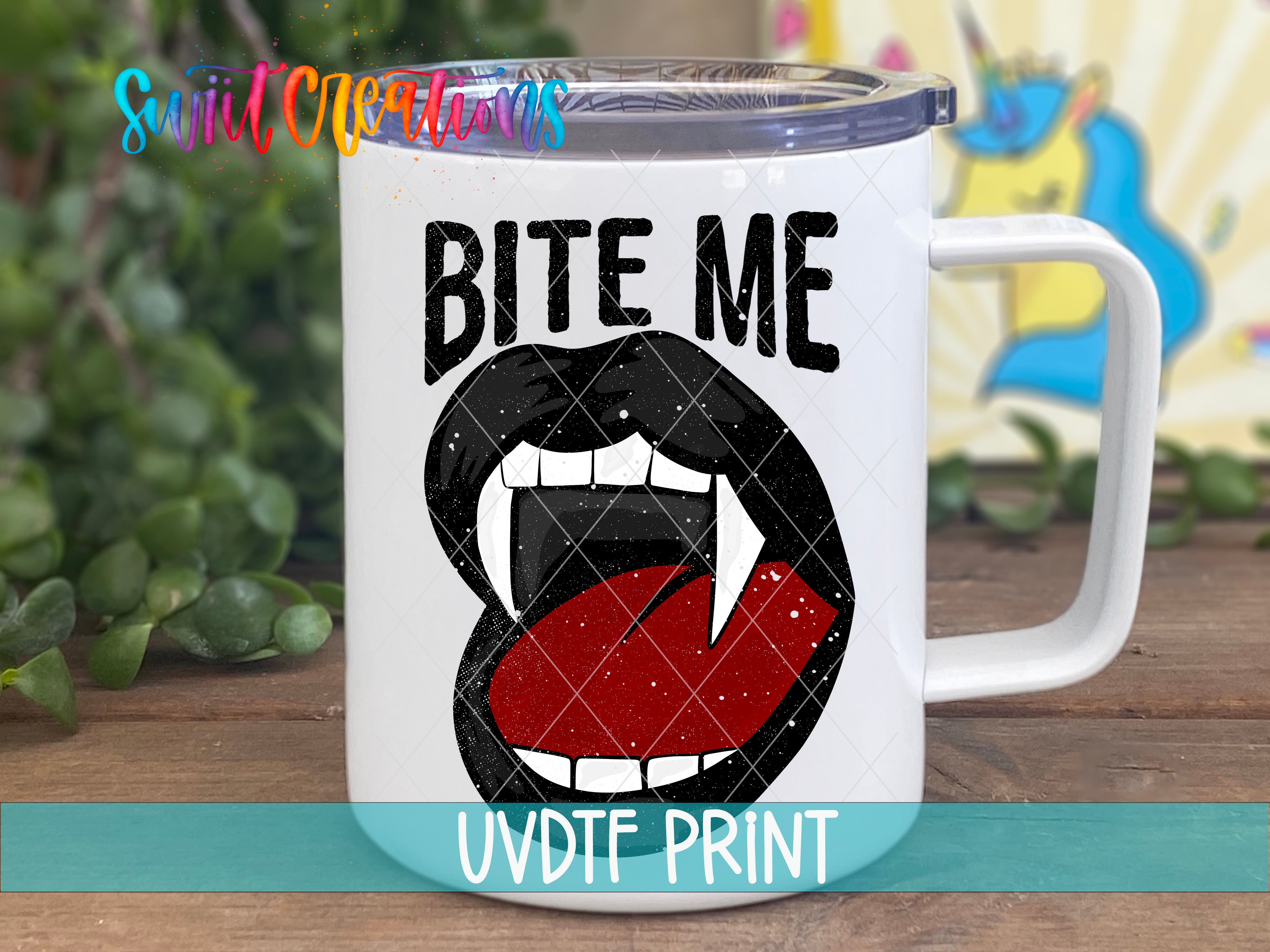 A white mug with a graphic design featuring a pair of black teeth and the text "BITE ME" printed on it.