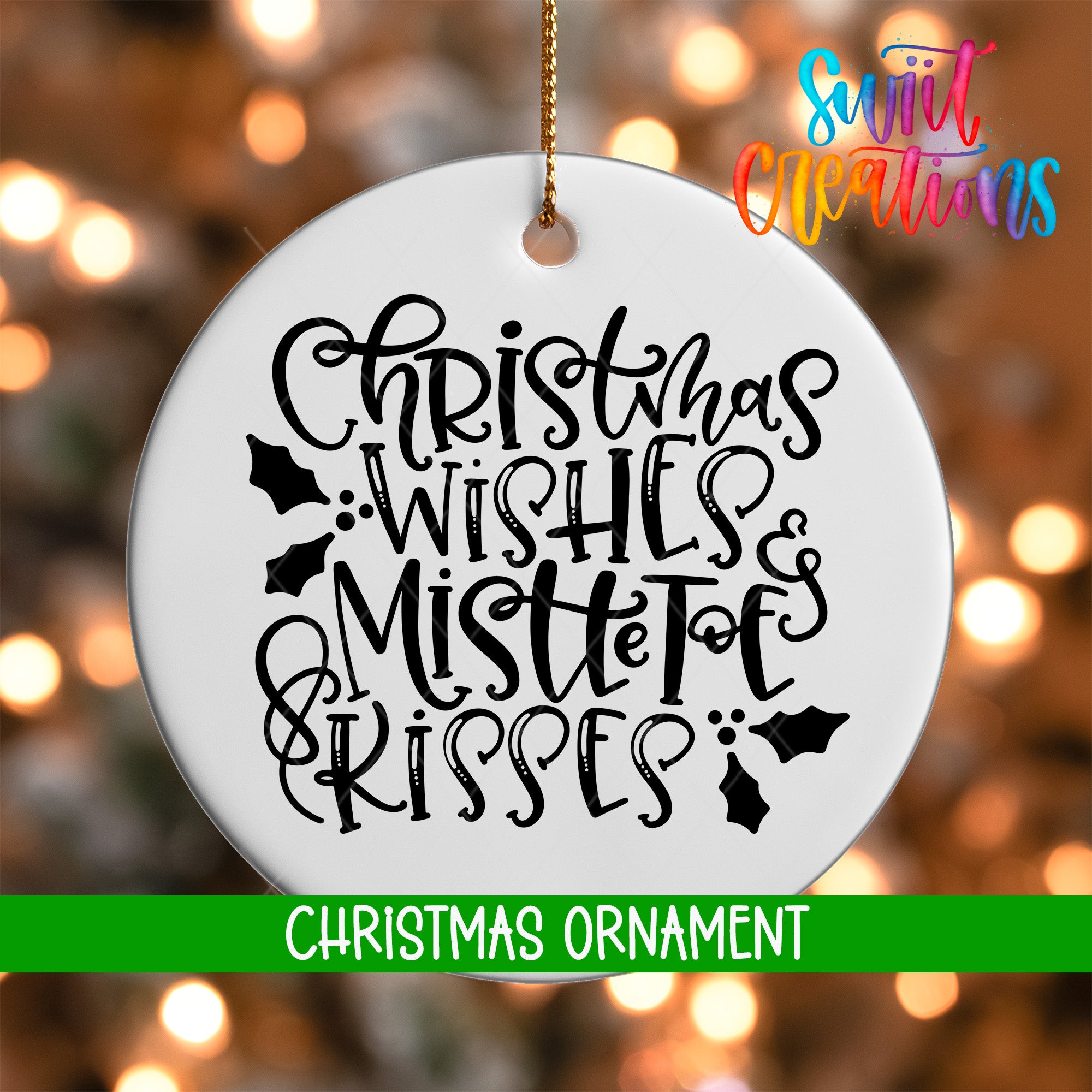 A white Christmas ornament with black text that says "Christmas Wishes & Mistle Toes Kisses" hanging on a string.