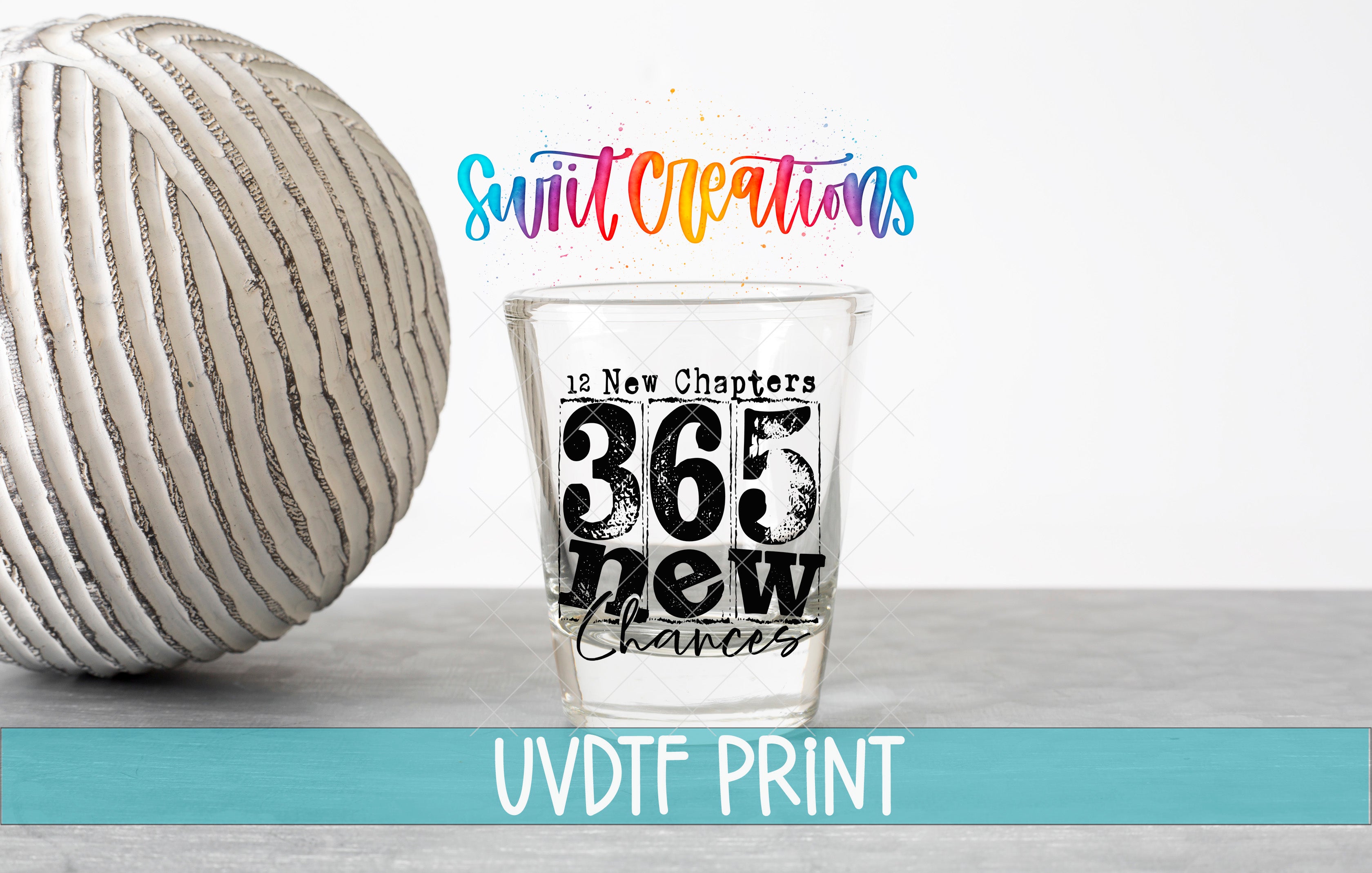 a shot glass with the text "365 New Chapters" and "12 New Chapters" printed on it, along with a colorful background that includes the text "Swift Creations" and "UVDF PRINT".
