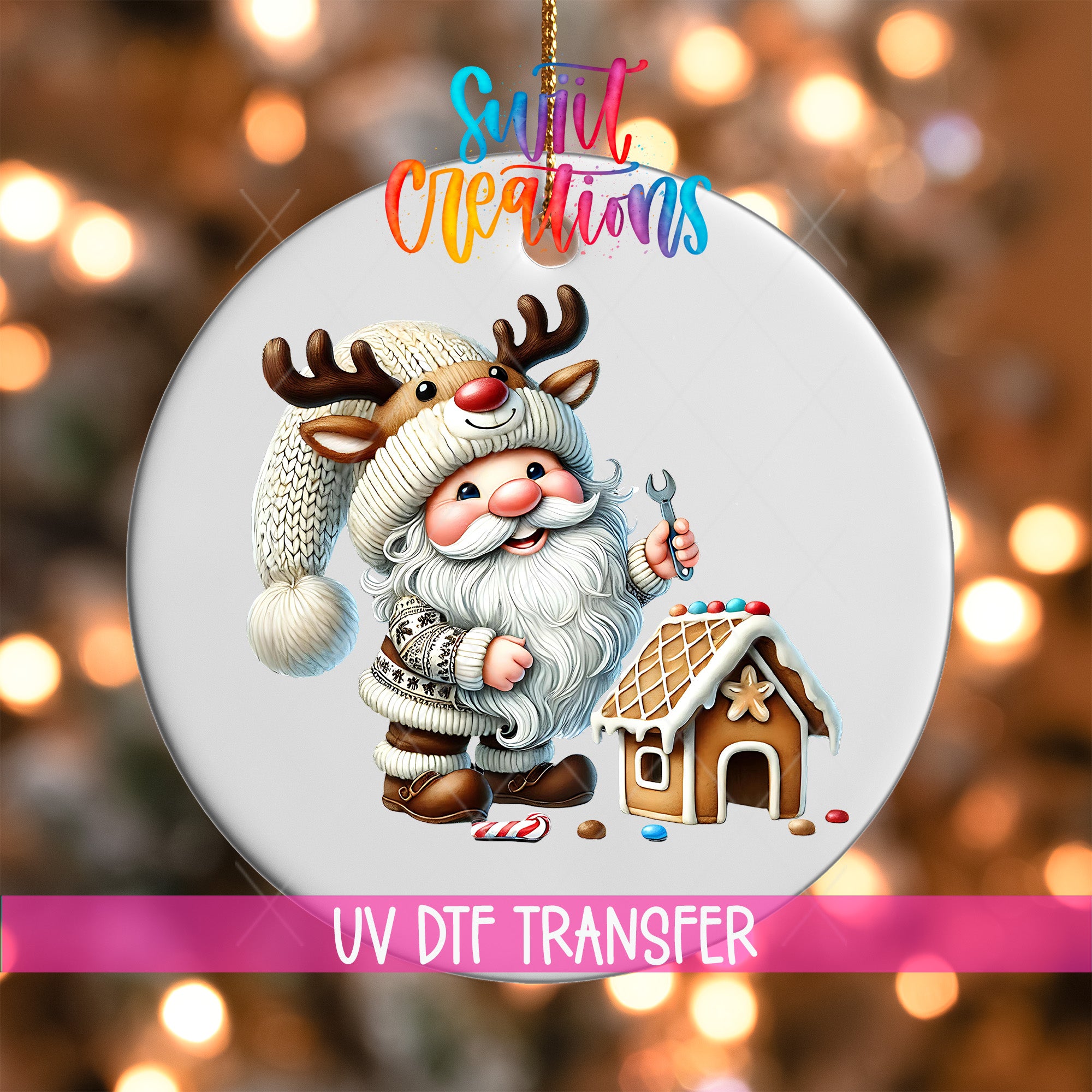 A Christmas ornament featuring a Santa Claus character with antlers and a gingerbread house, with a colorful background and text indicating it is a UV DFT transfer.