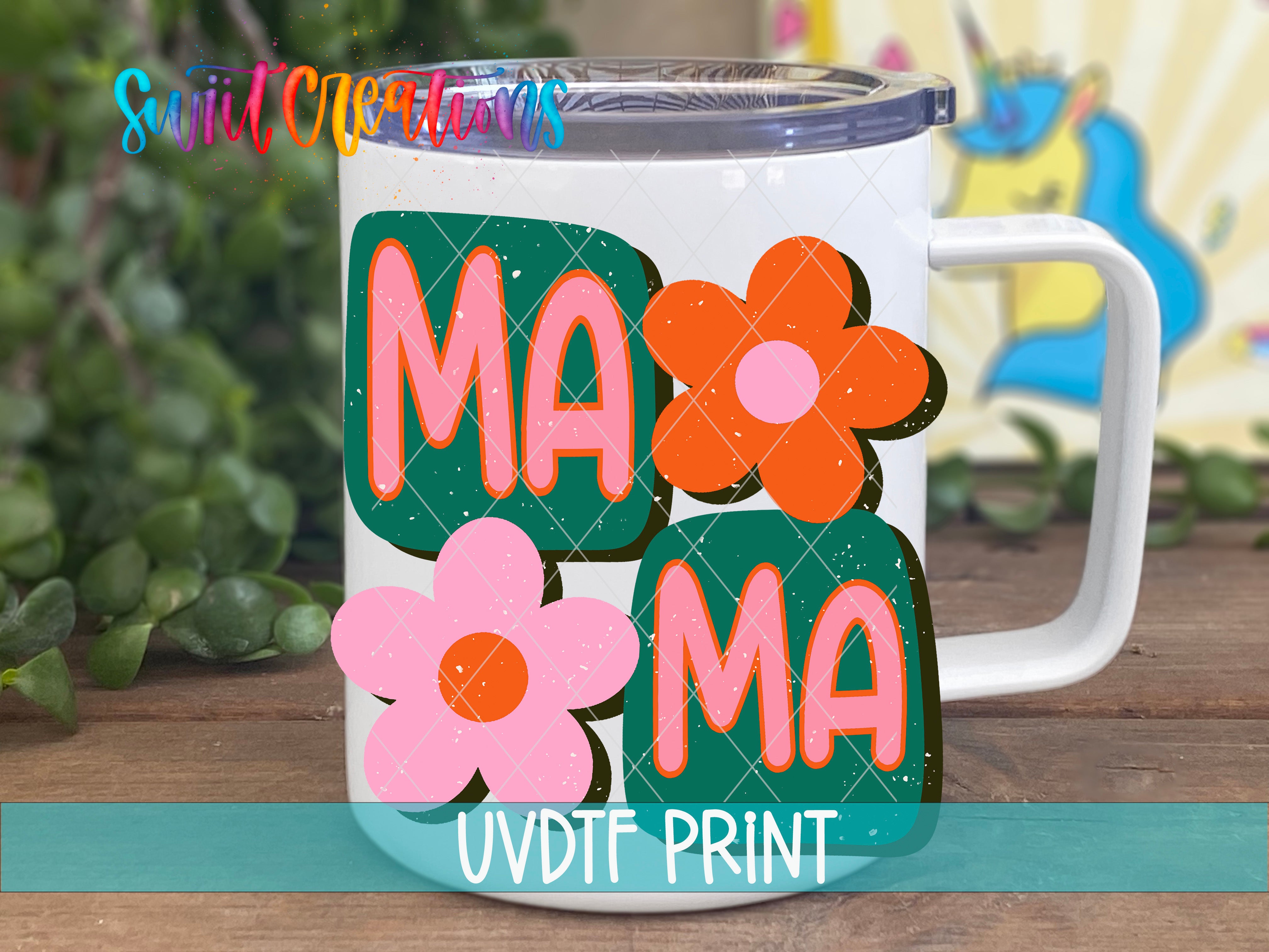A white mug with colorful flower designs and the text "MAMMA" printed on it.