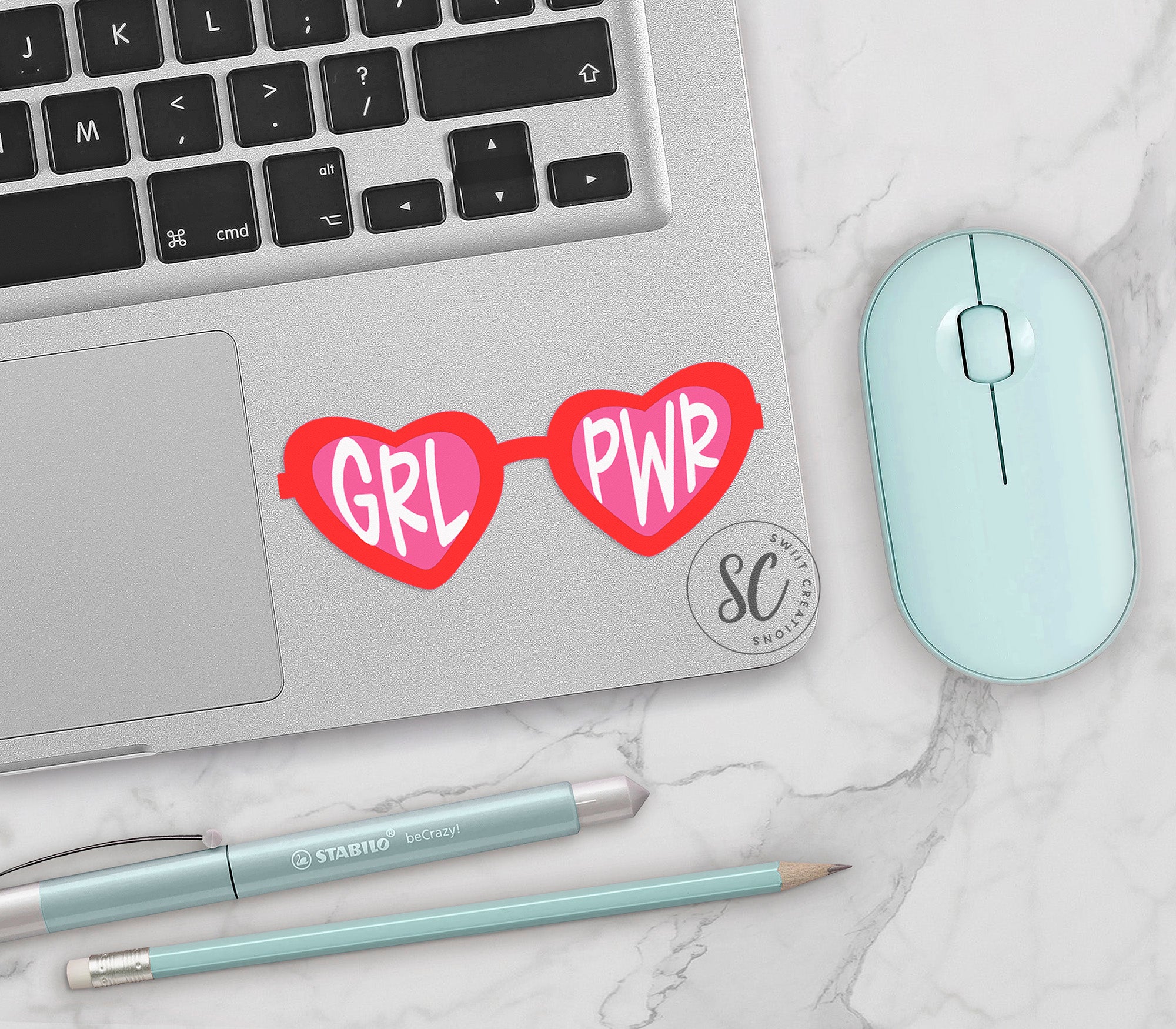 a laptop with a pair of heart shaped glasses on it