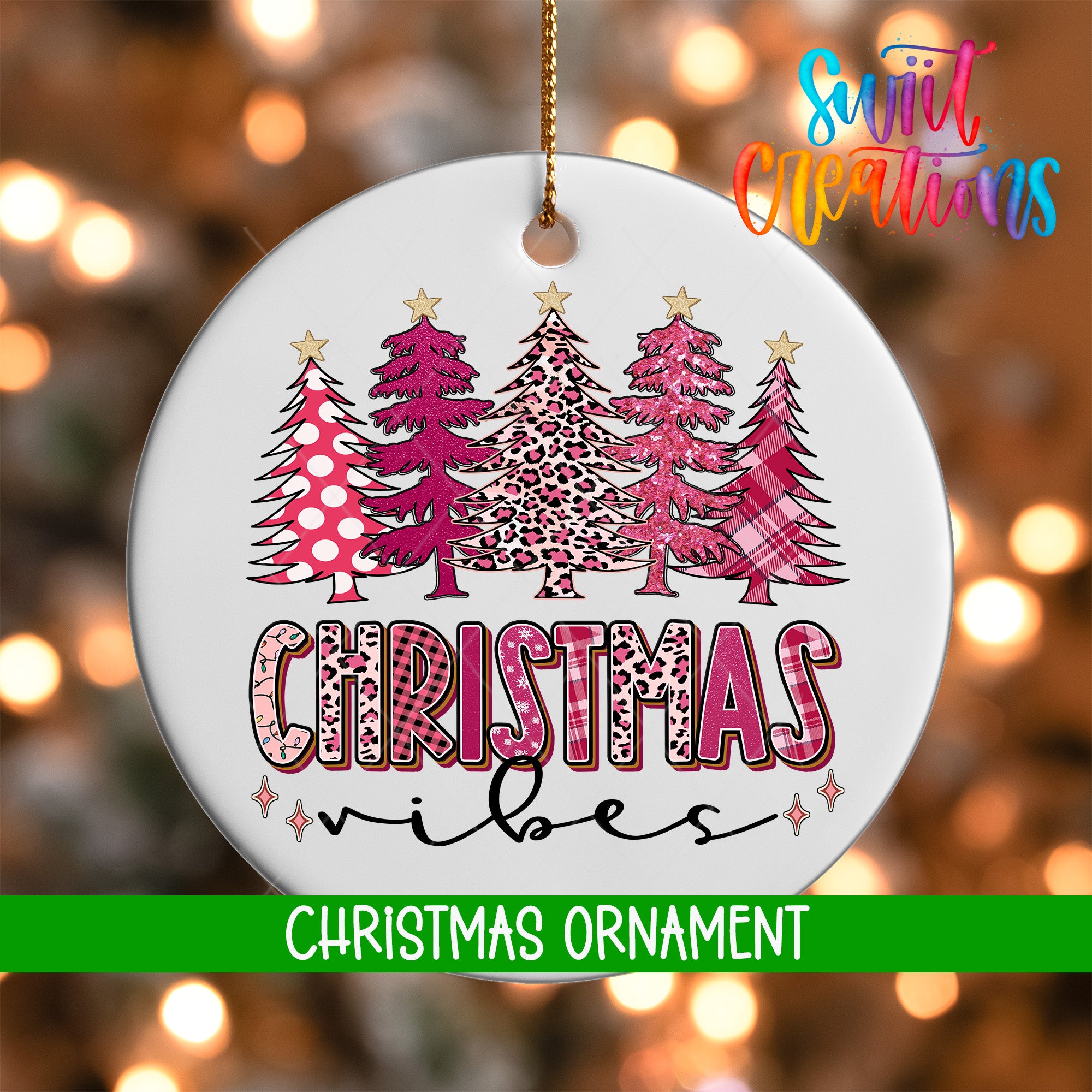 A white Christmas ornament with a design of pink and leopard print trees, along with the text "Christmas vibes" written in a stylized font.