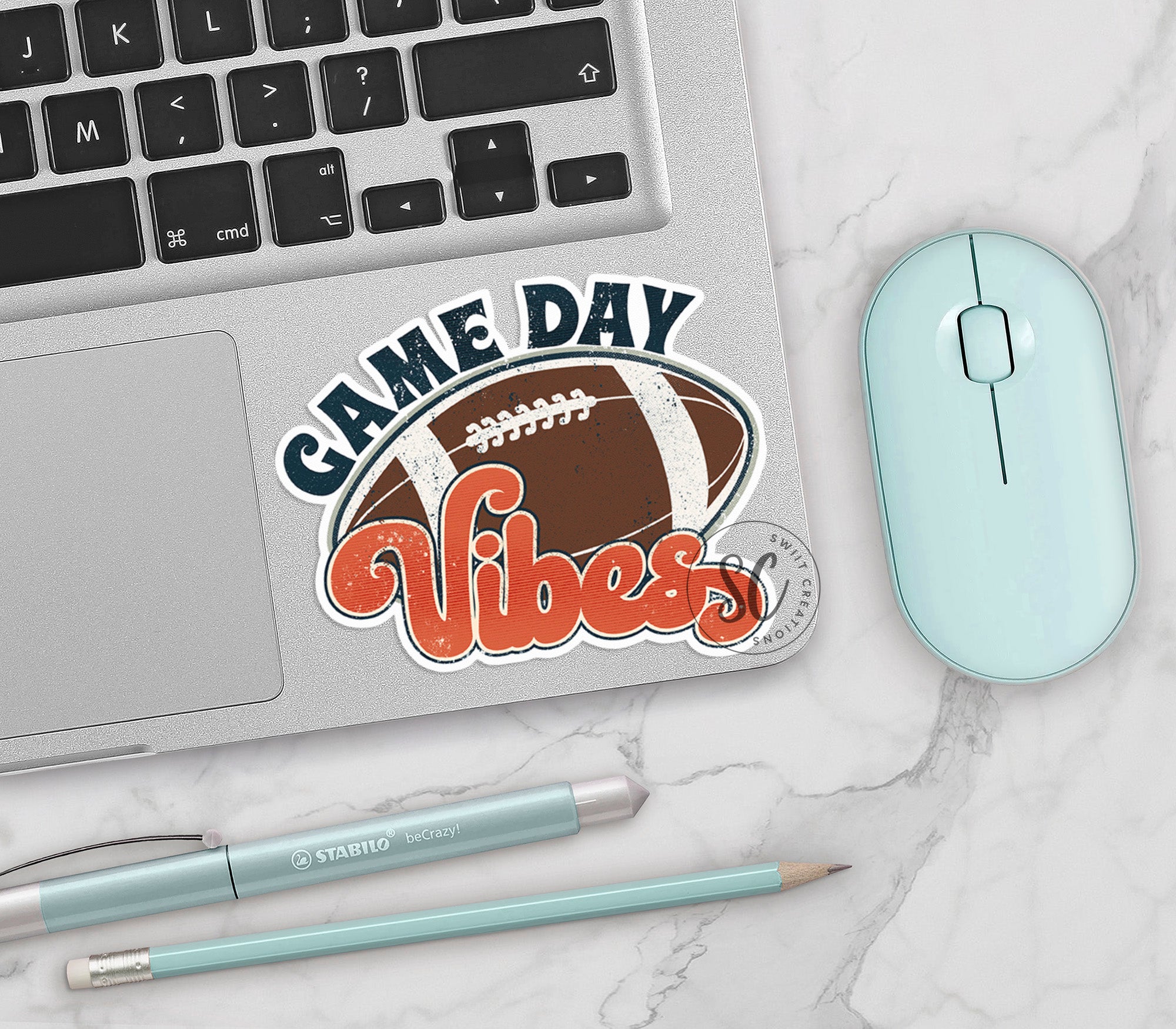 a laptop computer sitting next to a mouse