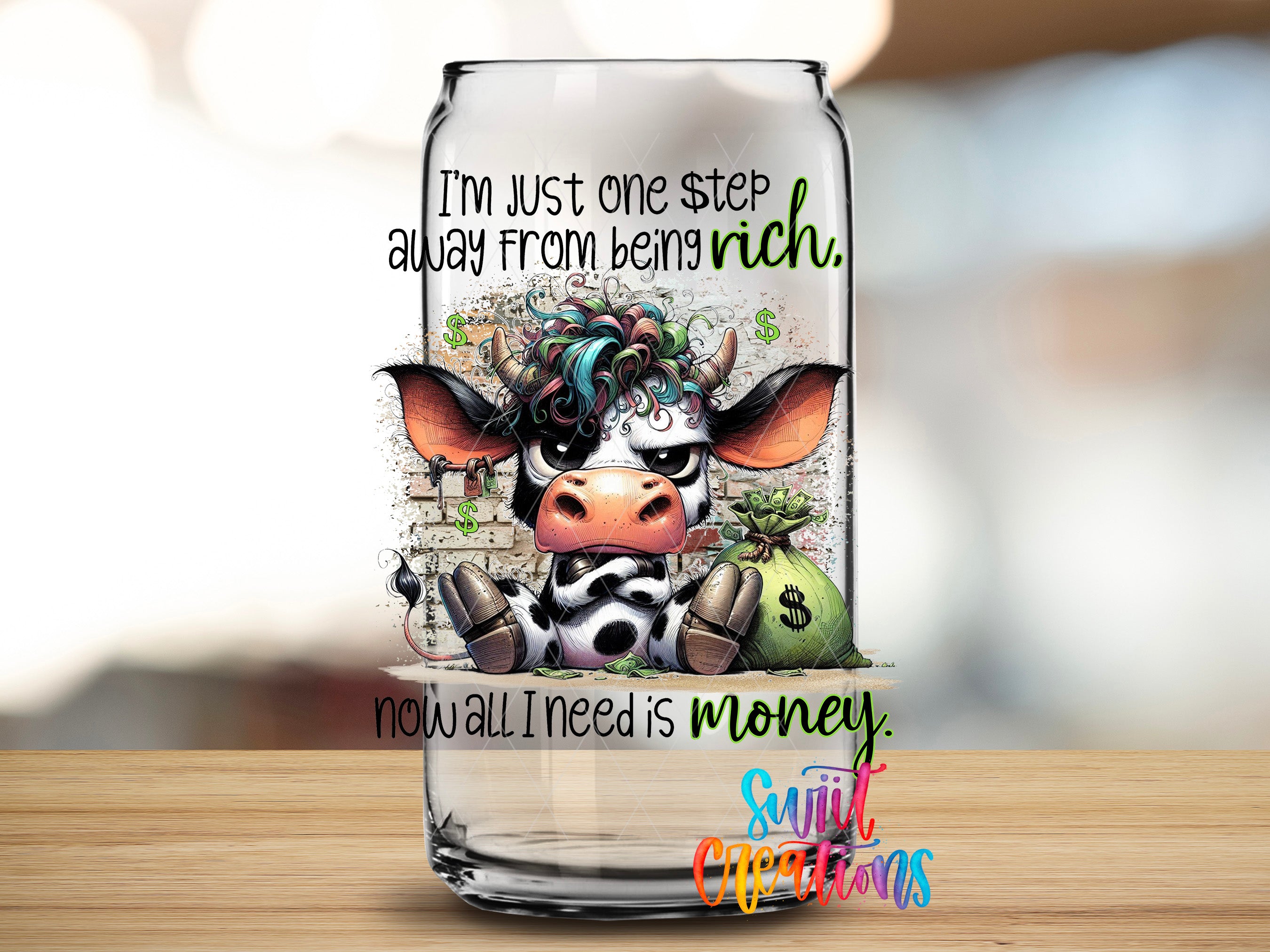 a glass can with a cartoon cow and text on it.