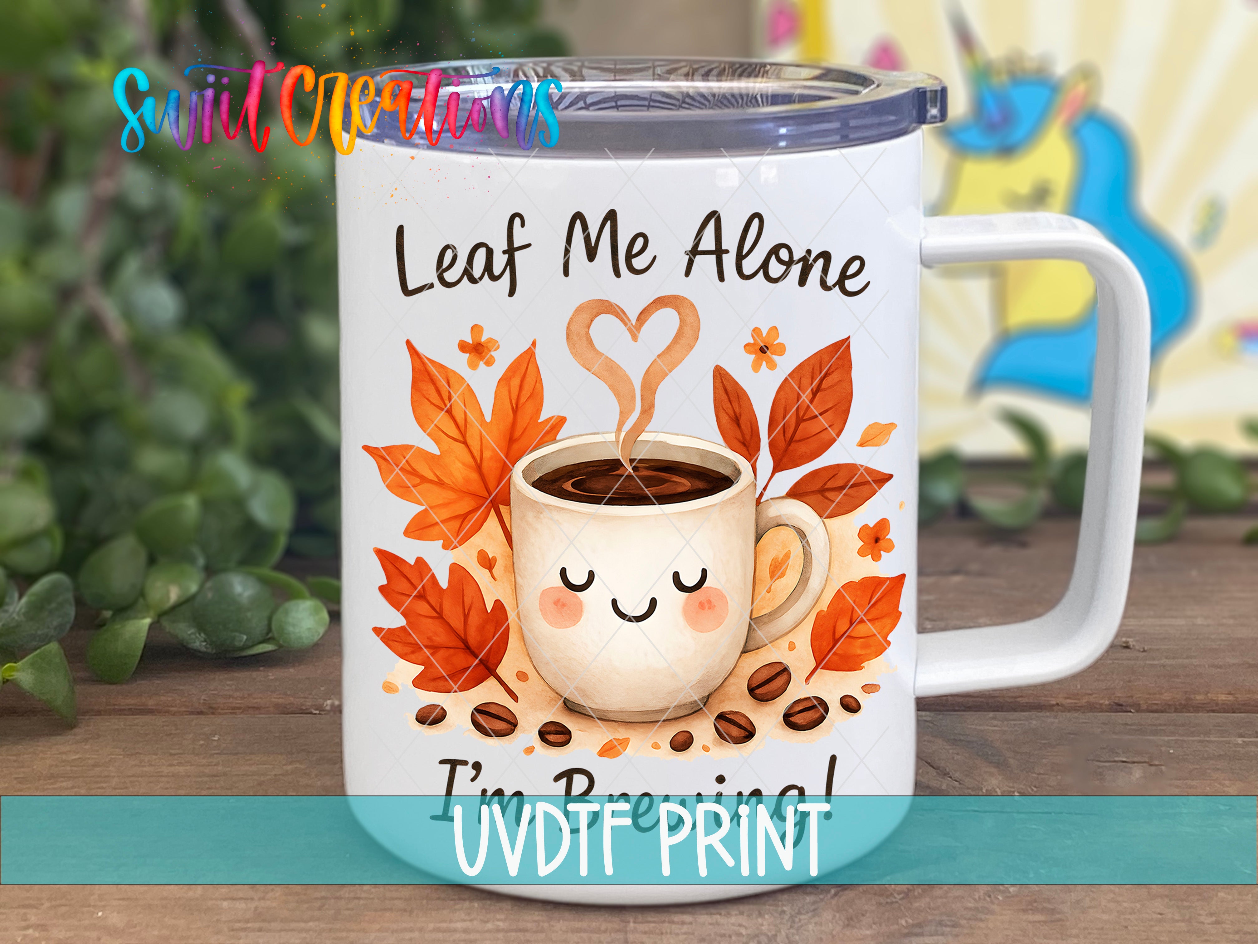 A white ceramic mug with a printed design featuring a smiling coffee cup surrounded by autumn leaves and coffee beans.