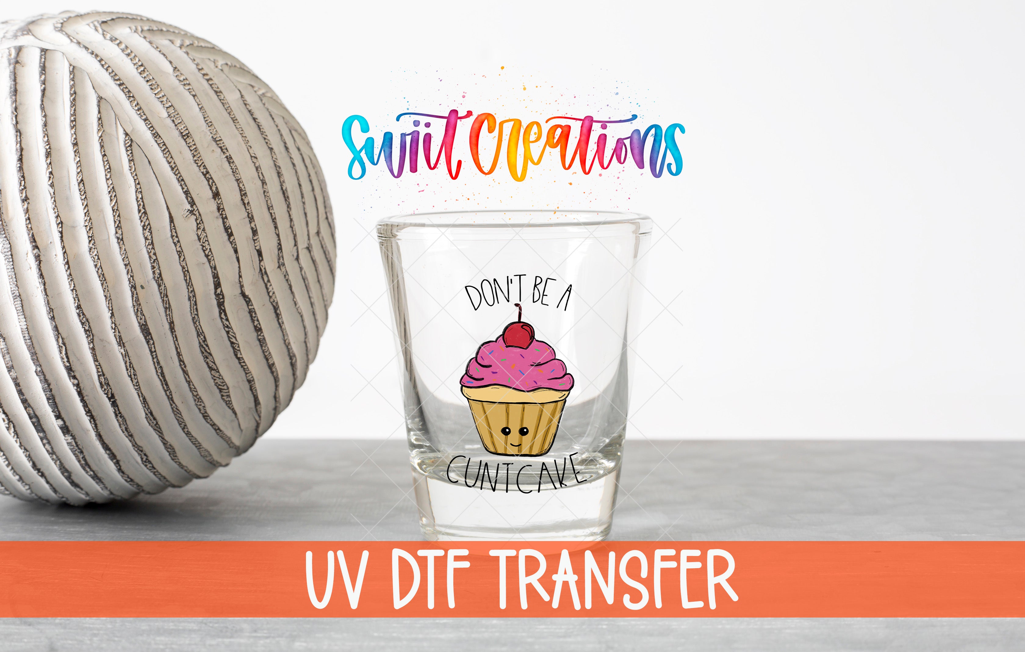 a glass with a cupcake design and a text that says "Don't be a Cuntcake" along with a colorful background.