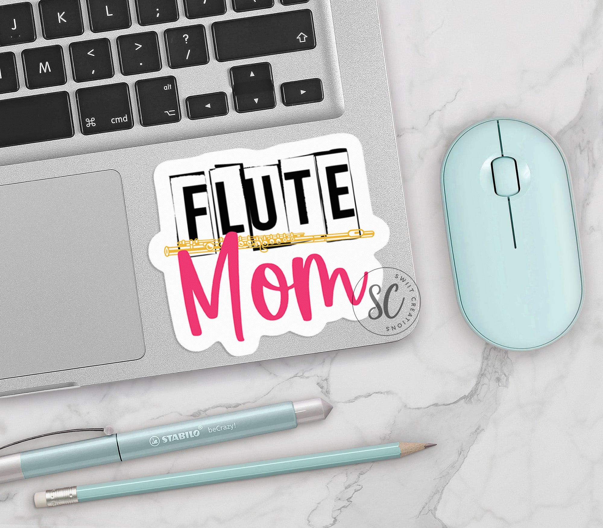 a laptop computer sitting on top of a white table