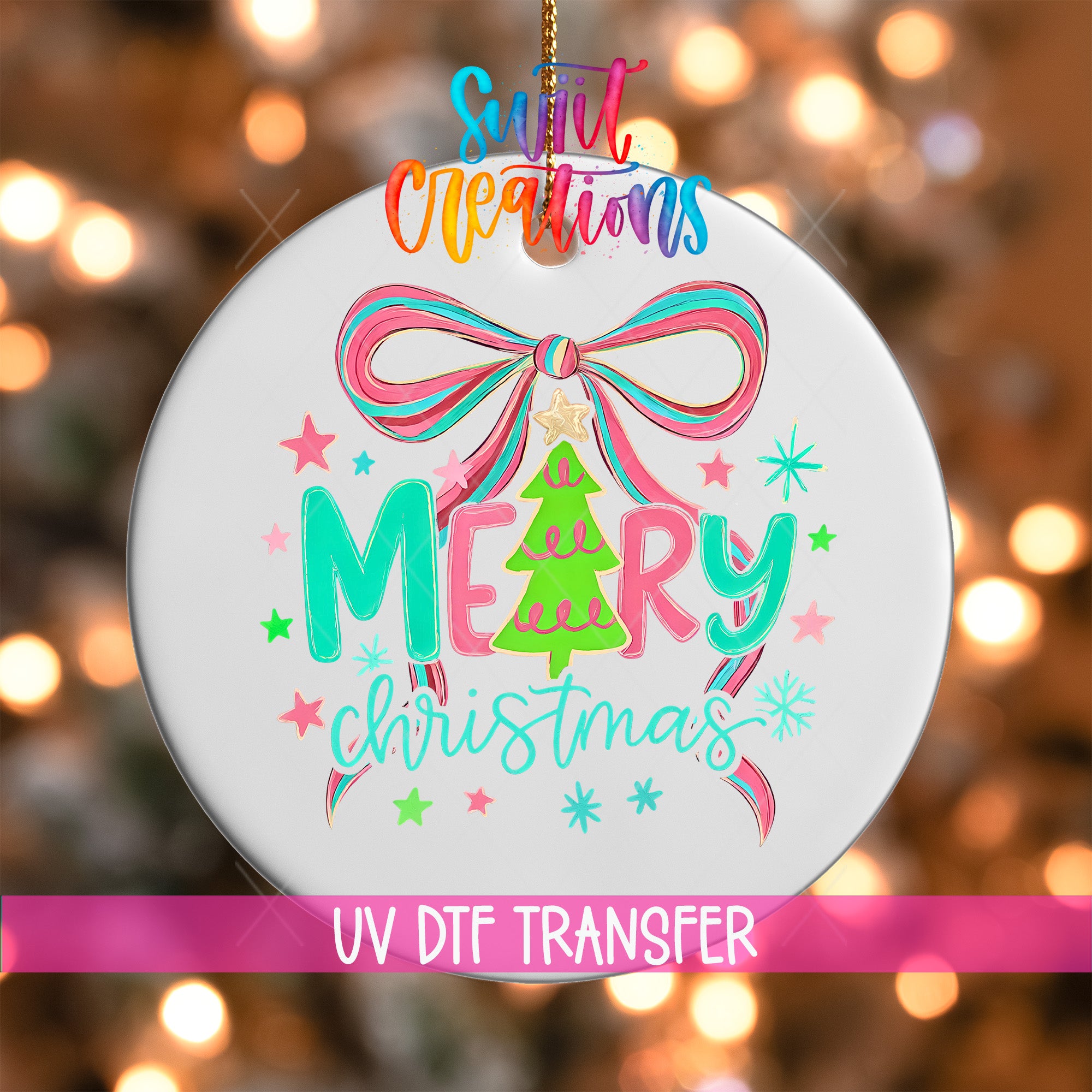 A white ornament with a colorful design featuring a bow, stars, and the text "Merry Christmas" is hanging against a blurred background with Christmas lights.