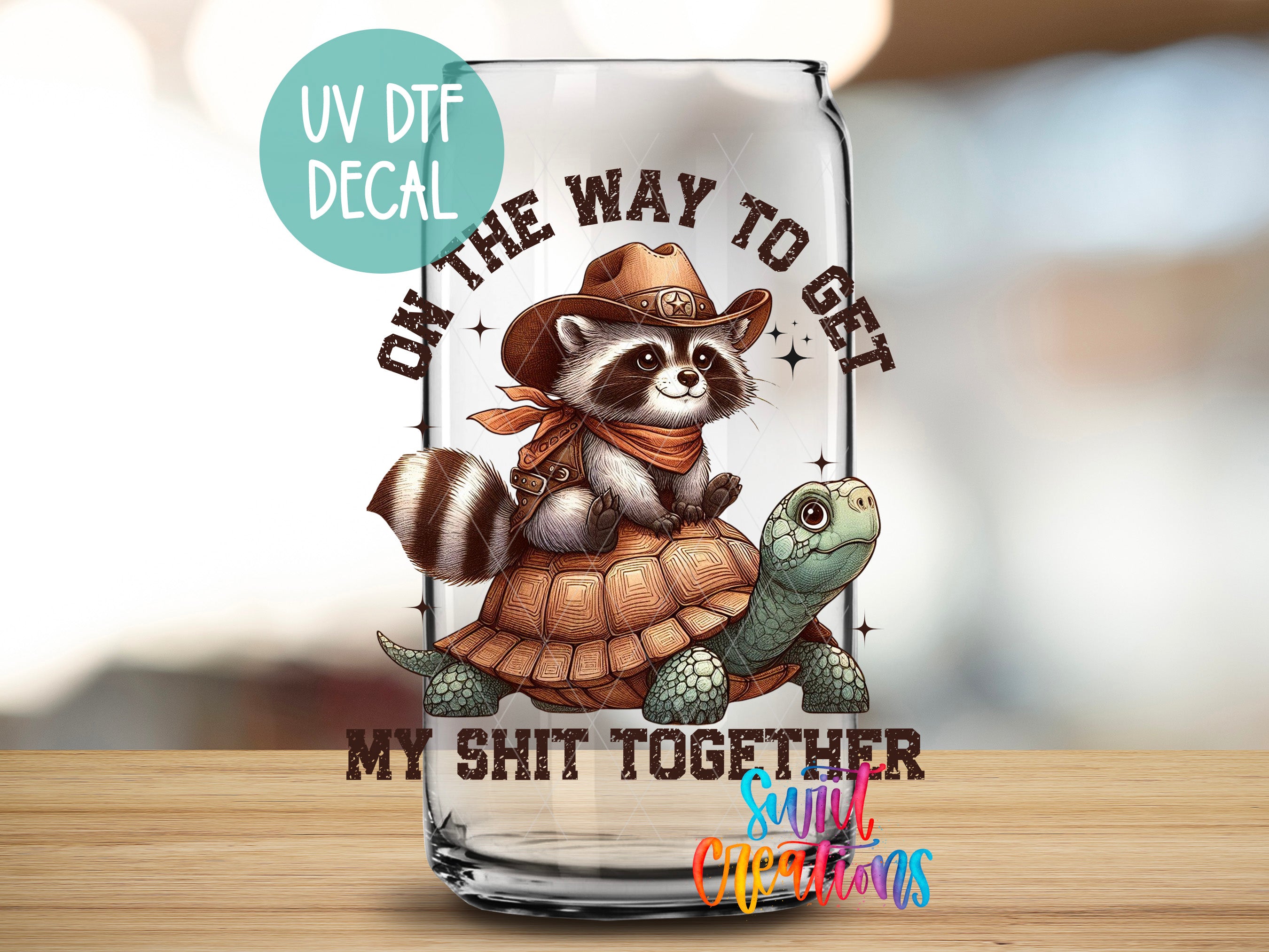 a glass with a picture of a raccoon riding a turtle